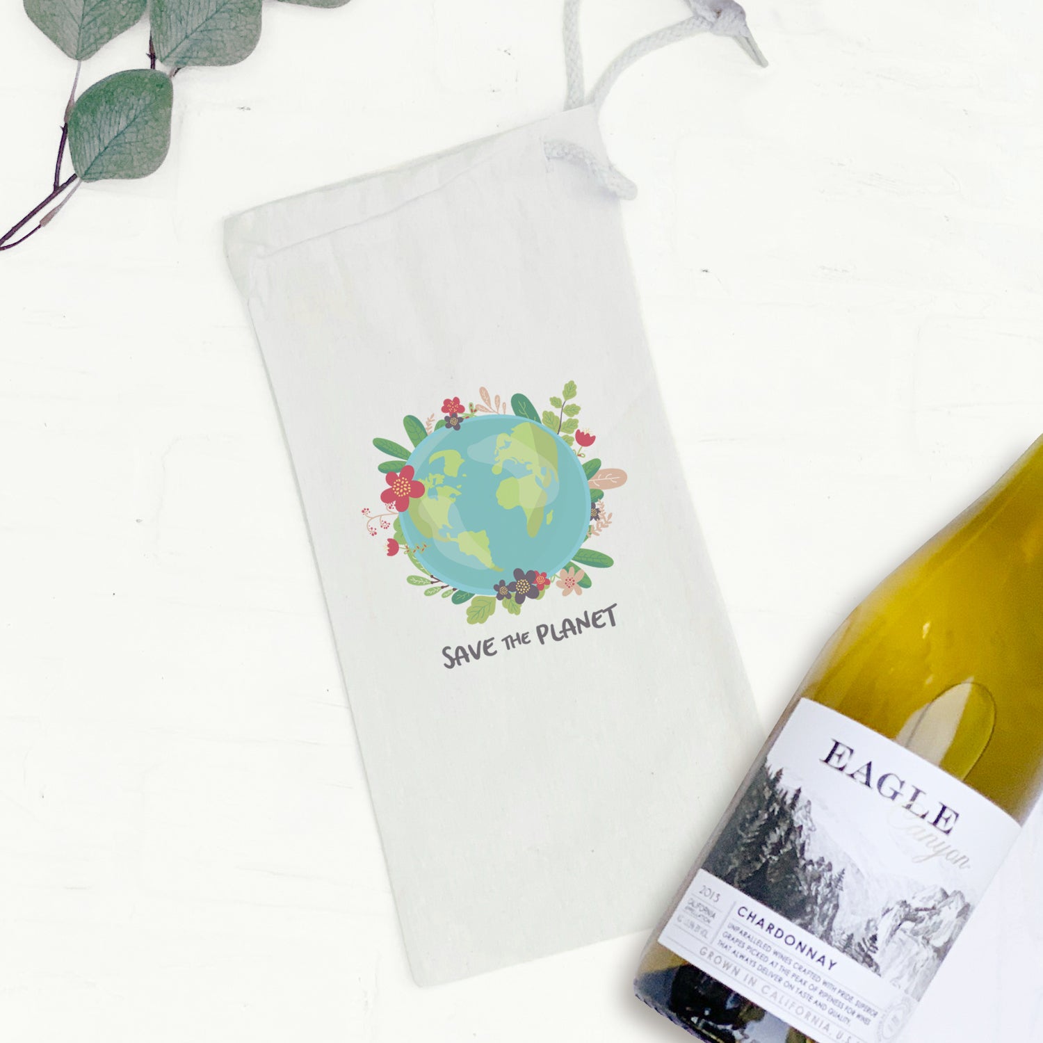 Eco-friendly canvas wine bag with drawstring closure, holding a 750mL bottle, perfect for gifting.