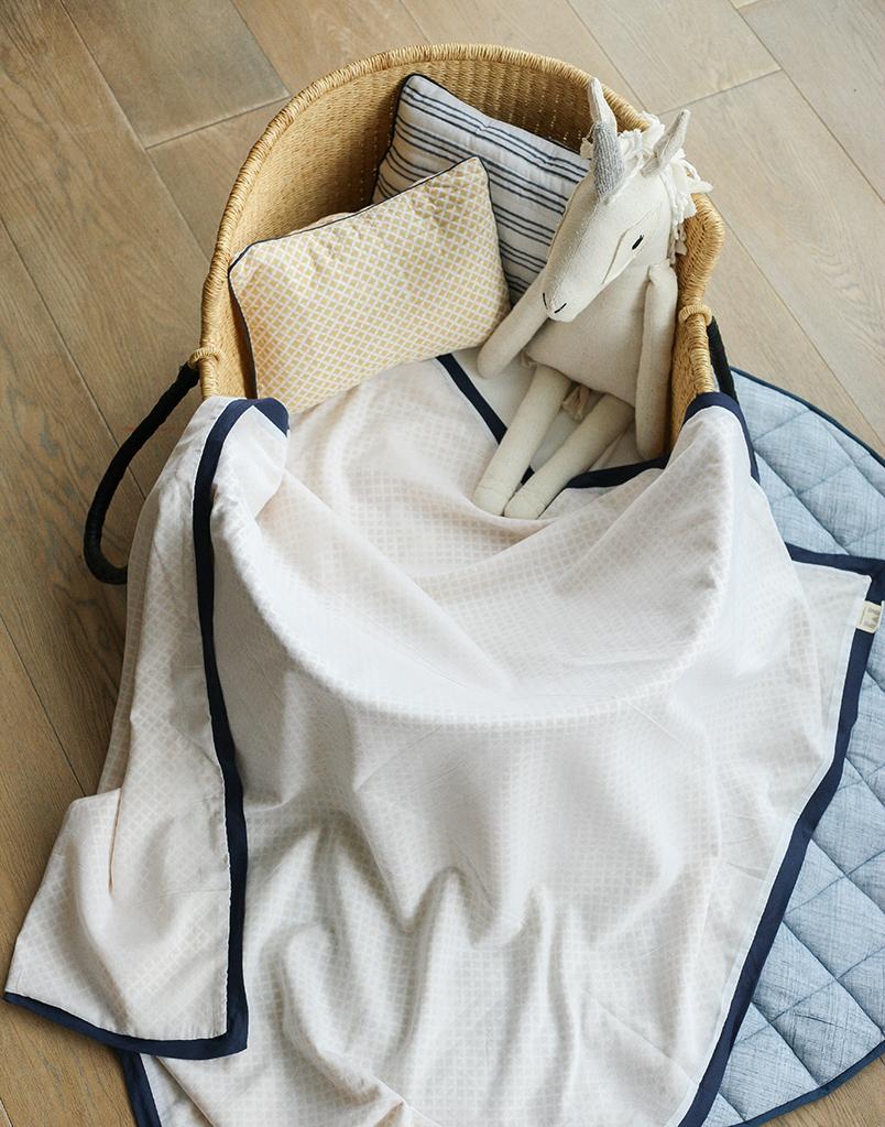 A soft Seminyak Blue Cotton Dohar featuring hand block-printed design, perfect for babies, showcasing its three layers of breathable cotton.