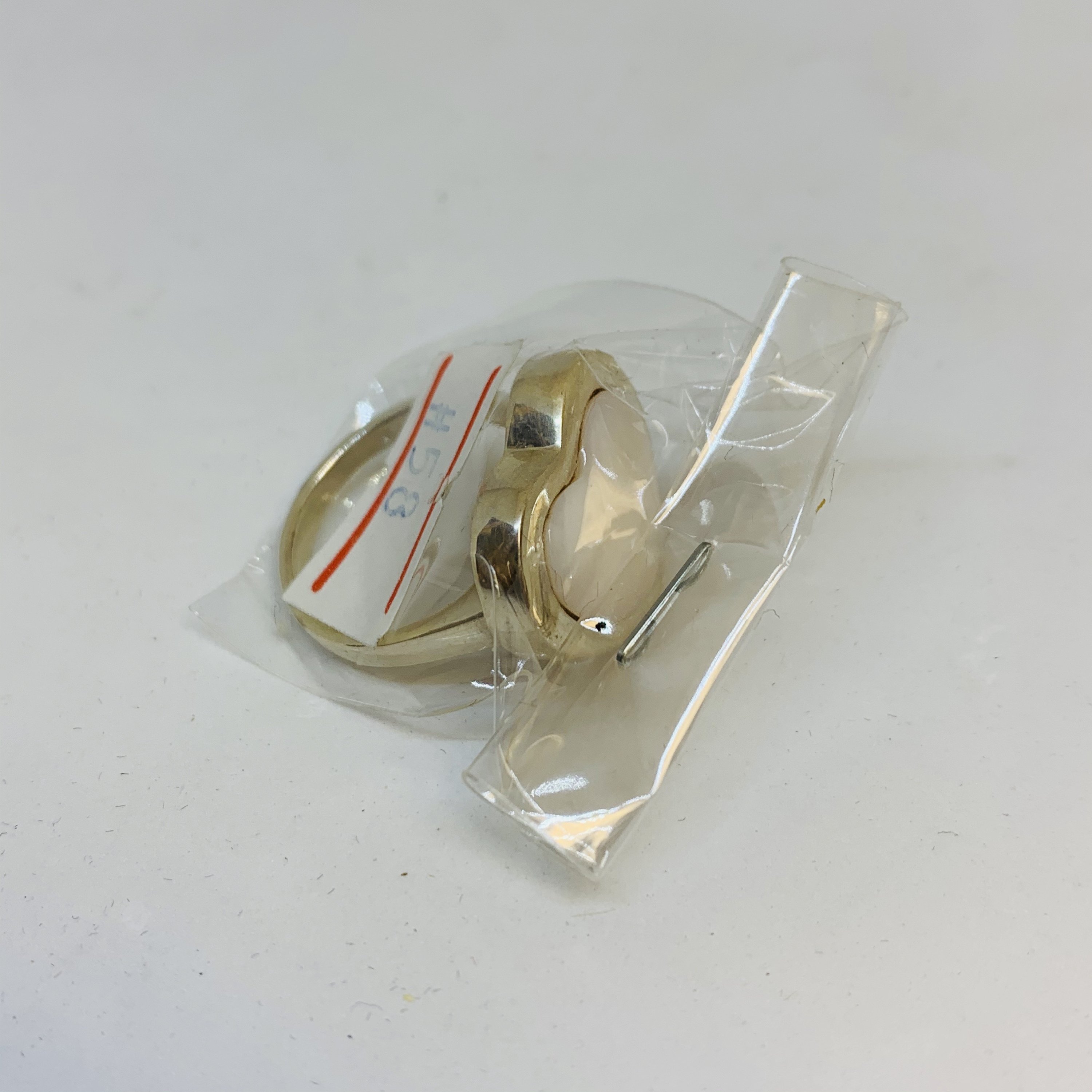 A stunning Silver Mother Of Pearl Ring featuring a heart-shaped design, crafted from 925 sterling silver, showcasing its elegant and protective qualities.