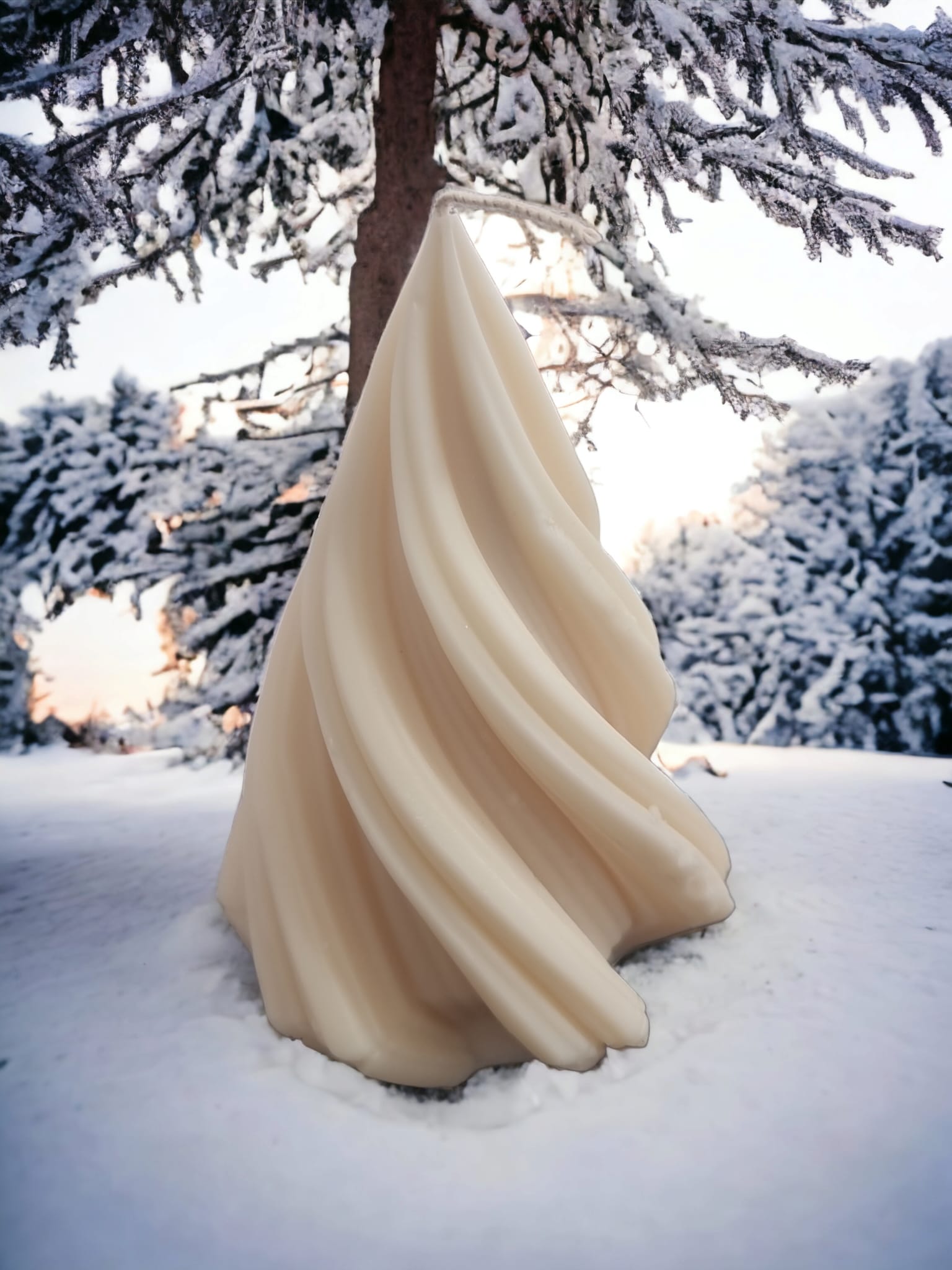 A beautifully crafted Snowy Vanilla Cream Scented Christmas Tree Candle, featuring a creamy vanilla color and a festive design, perfect for holiday decor.