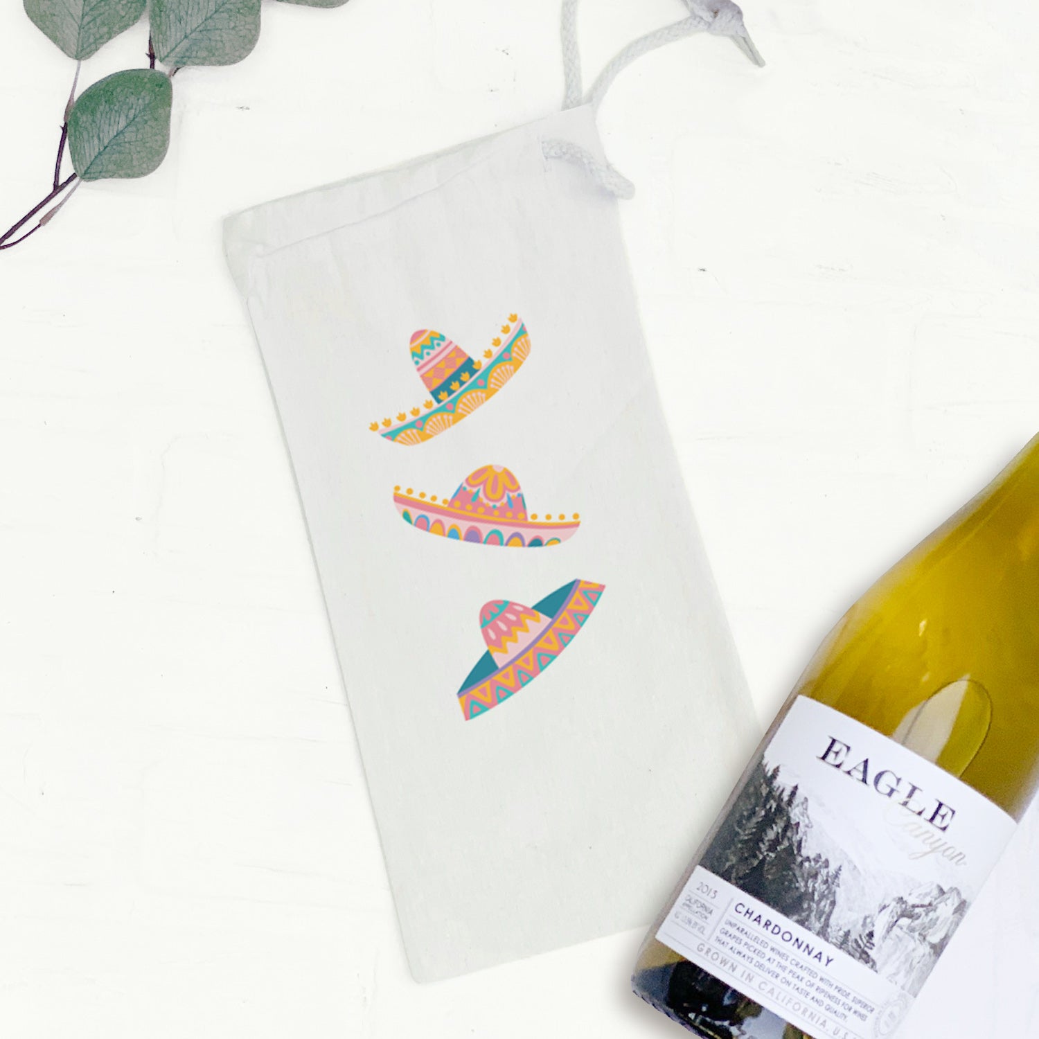 Sombreros Canvas Wine Bag featuring a stylish design with a drawstring closure, perfect for carrying wine bottles.