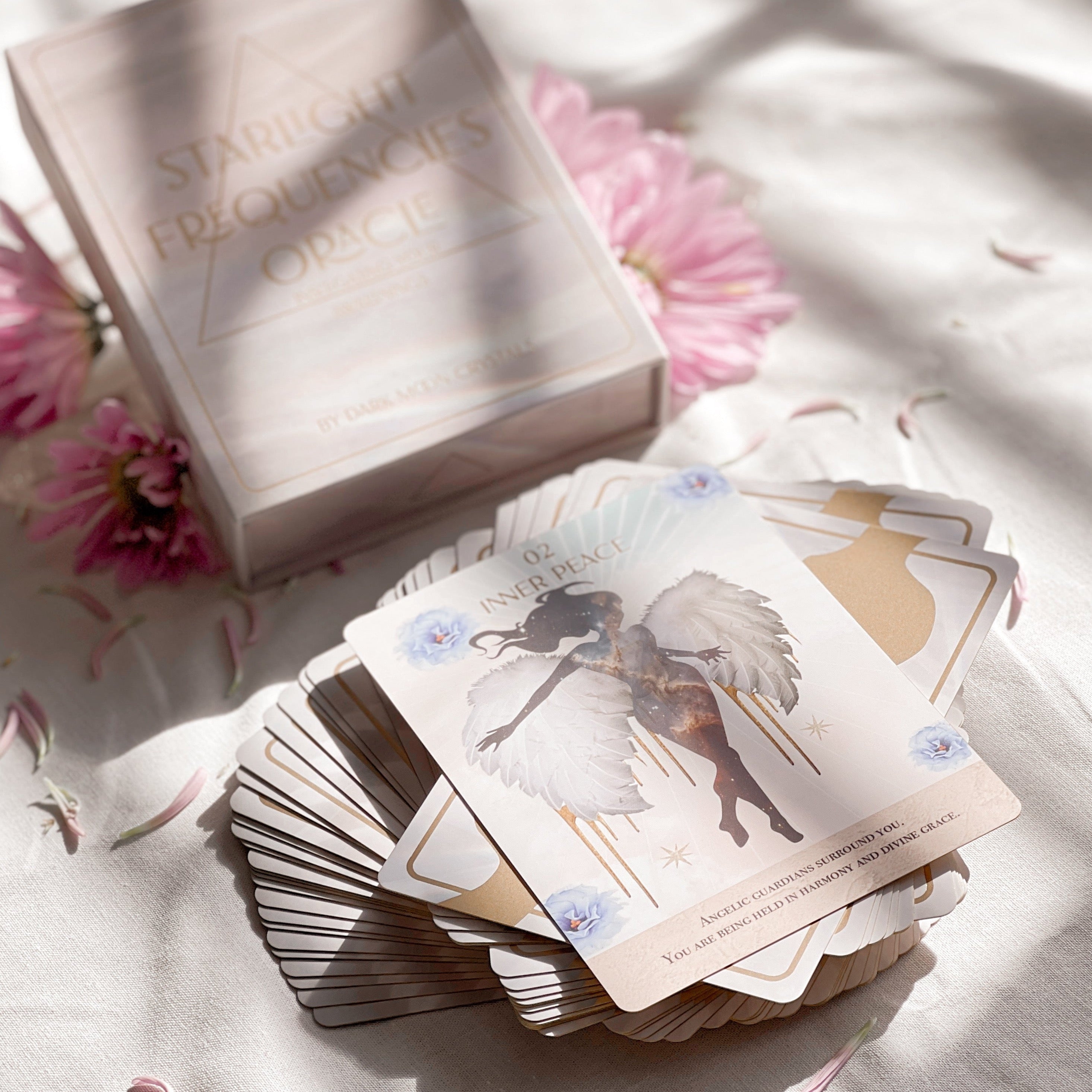 Starlight Frequencies Oracle Deck featuring 44 cards with gold foil accents and a velvet texture, displayed in a magnetic flip box.