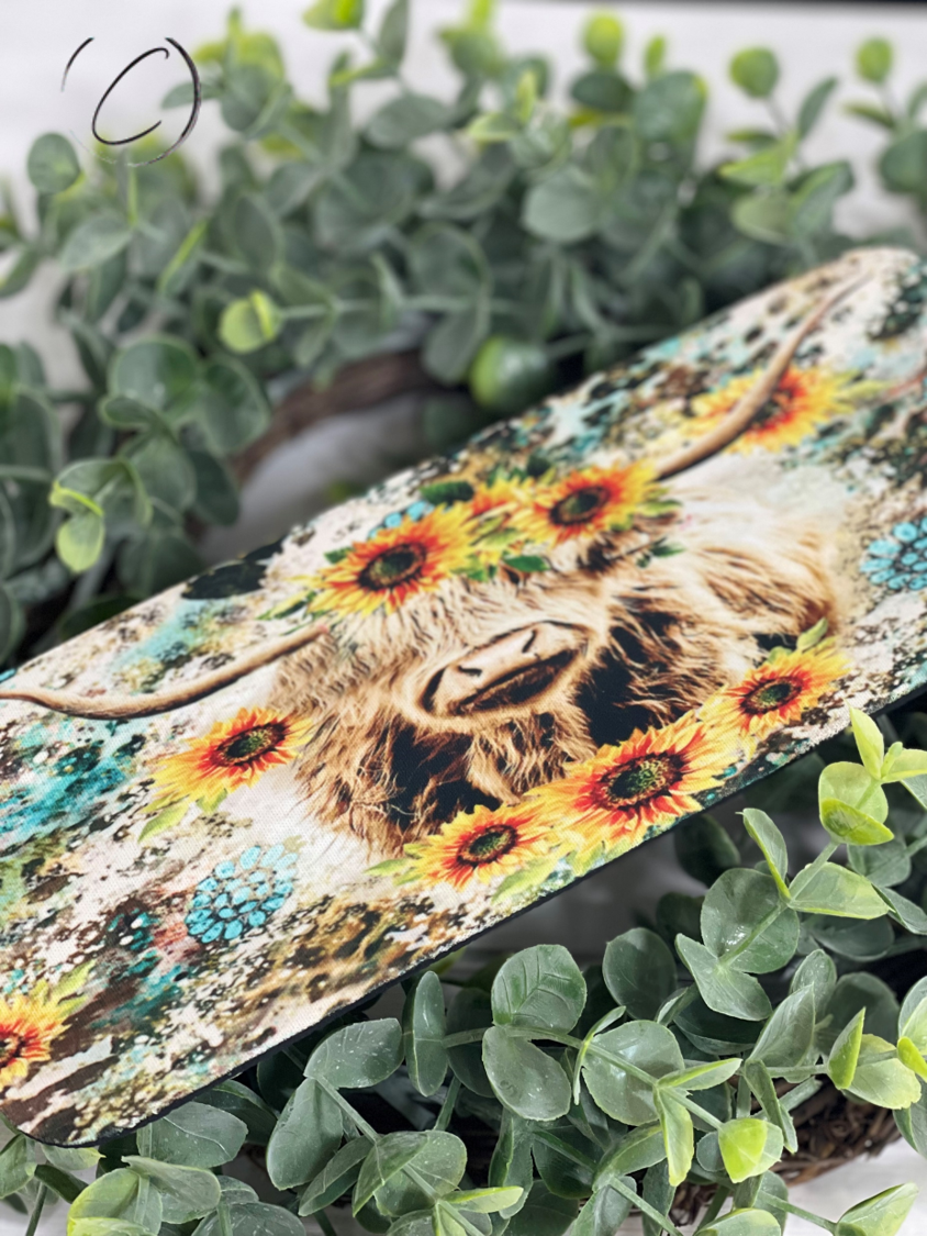 Sunflower Highland Cow Slap Wrap Can Cooler featuring a vibrant design, perfect for keeping drinks cold.