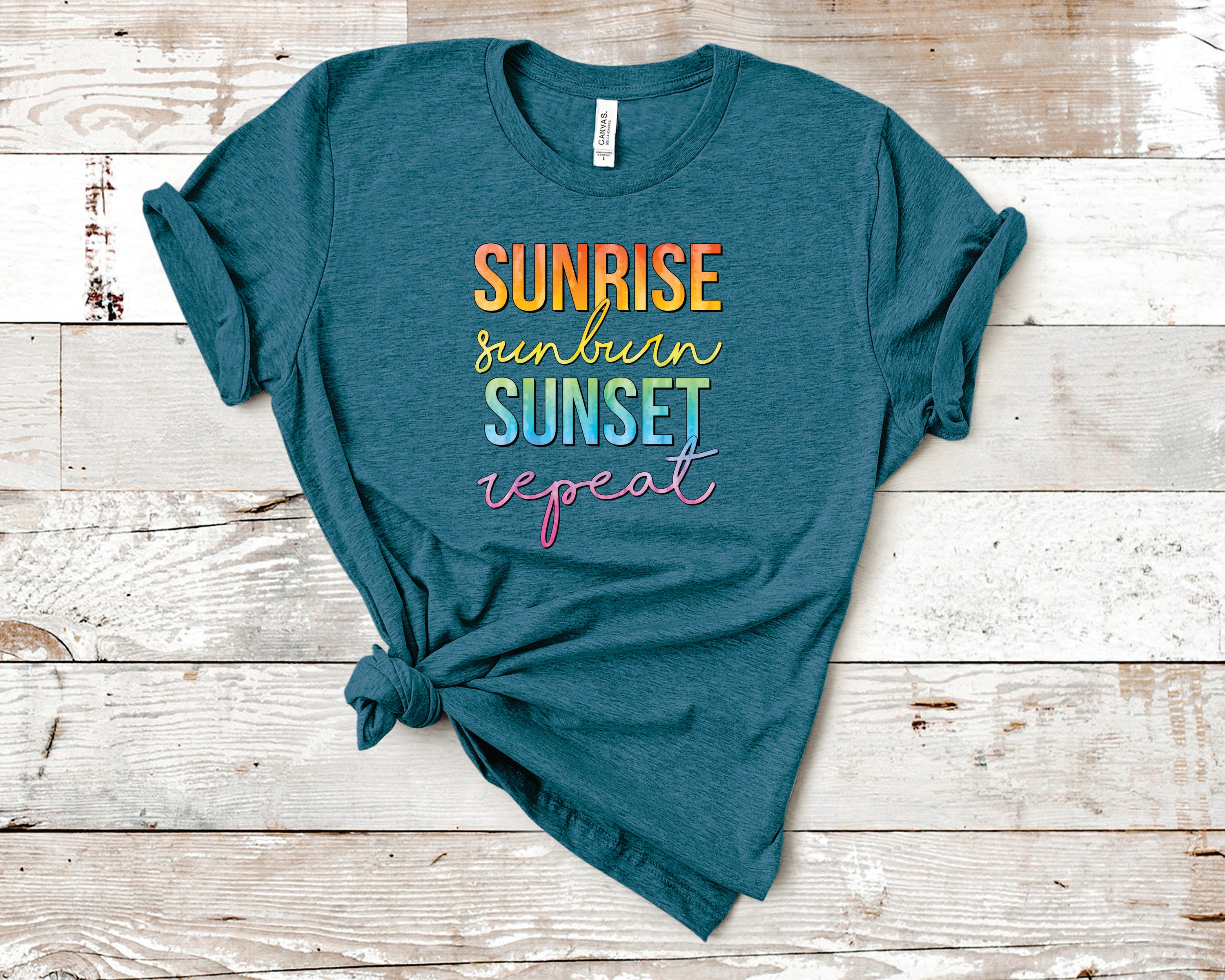 A vibrant unisex graphic tee featuring the phrase 'Sunrise Sunburn Sunset Repeat' in colorful print, perfect for summer wear.