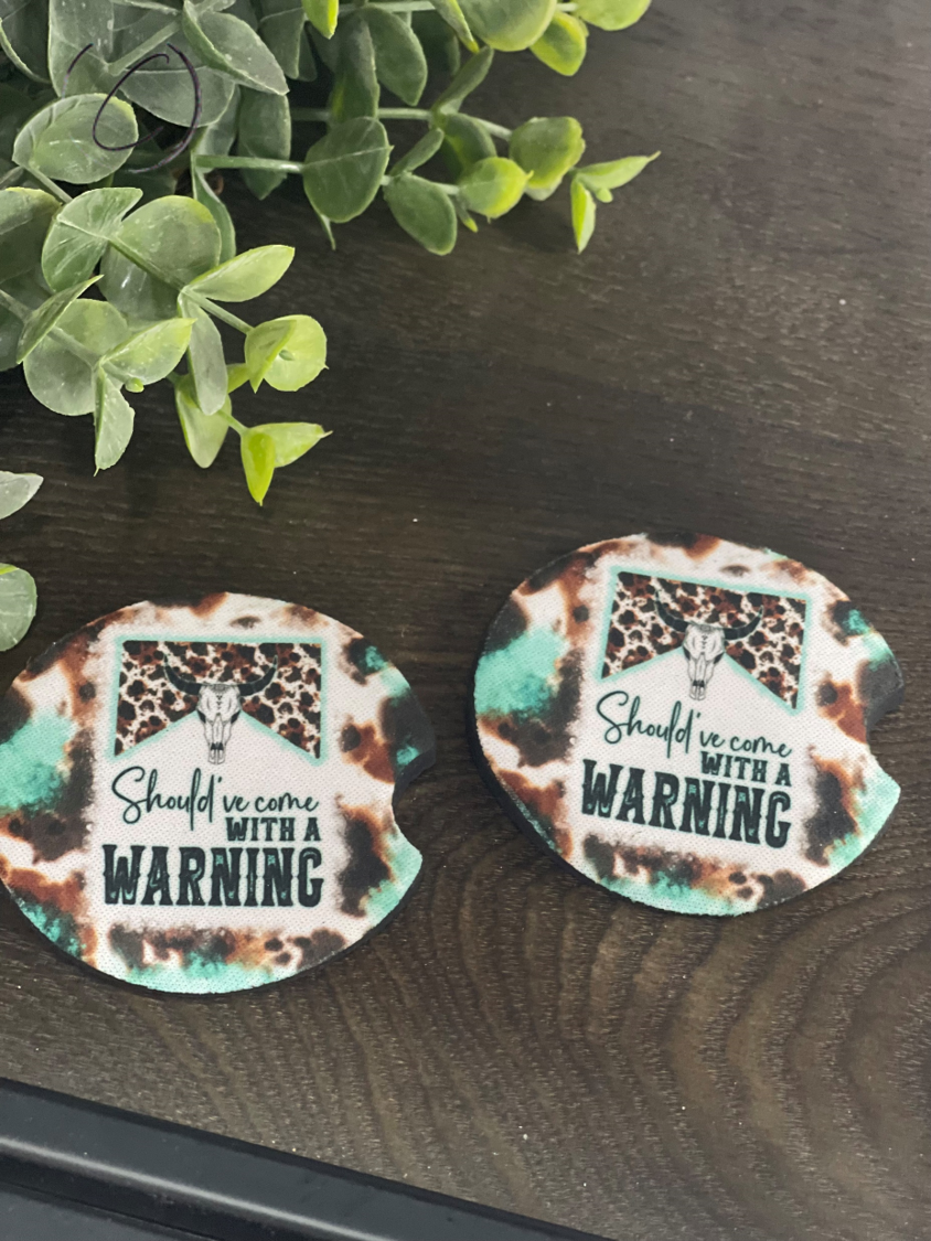 Teal car coasters featuring glitter peacock feather design, made of durable neoprene, perfect for cup holders.