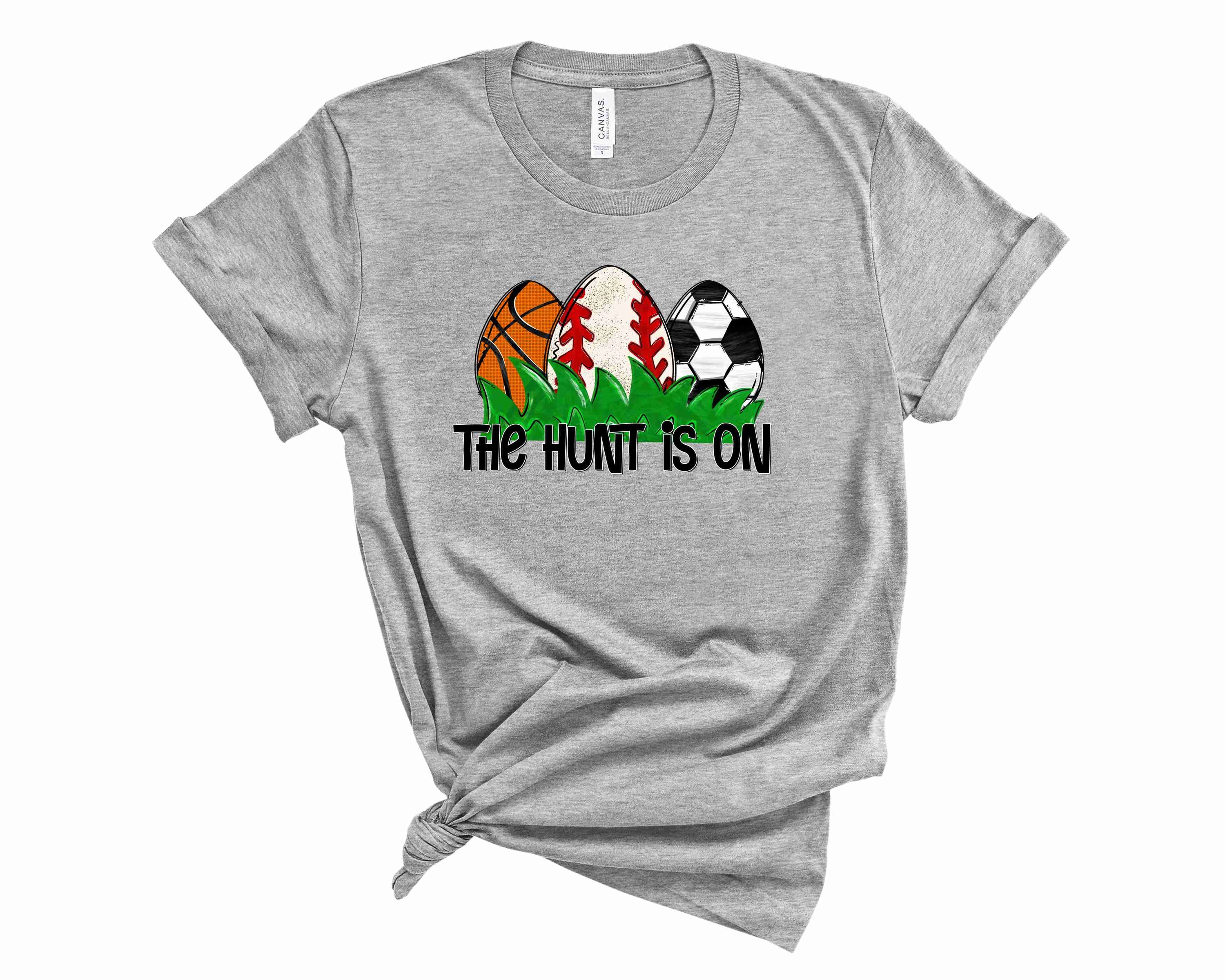 A unisex graphic tee featuring 'The Hunt is On' design, perfect for sports enthusiasts, showcasing vibrant colors and a stylish fit.