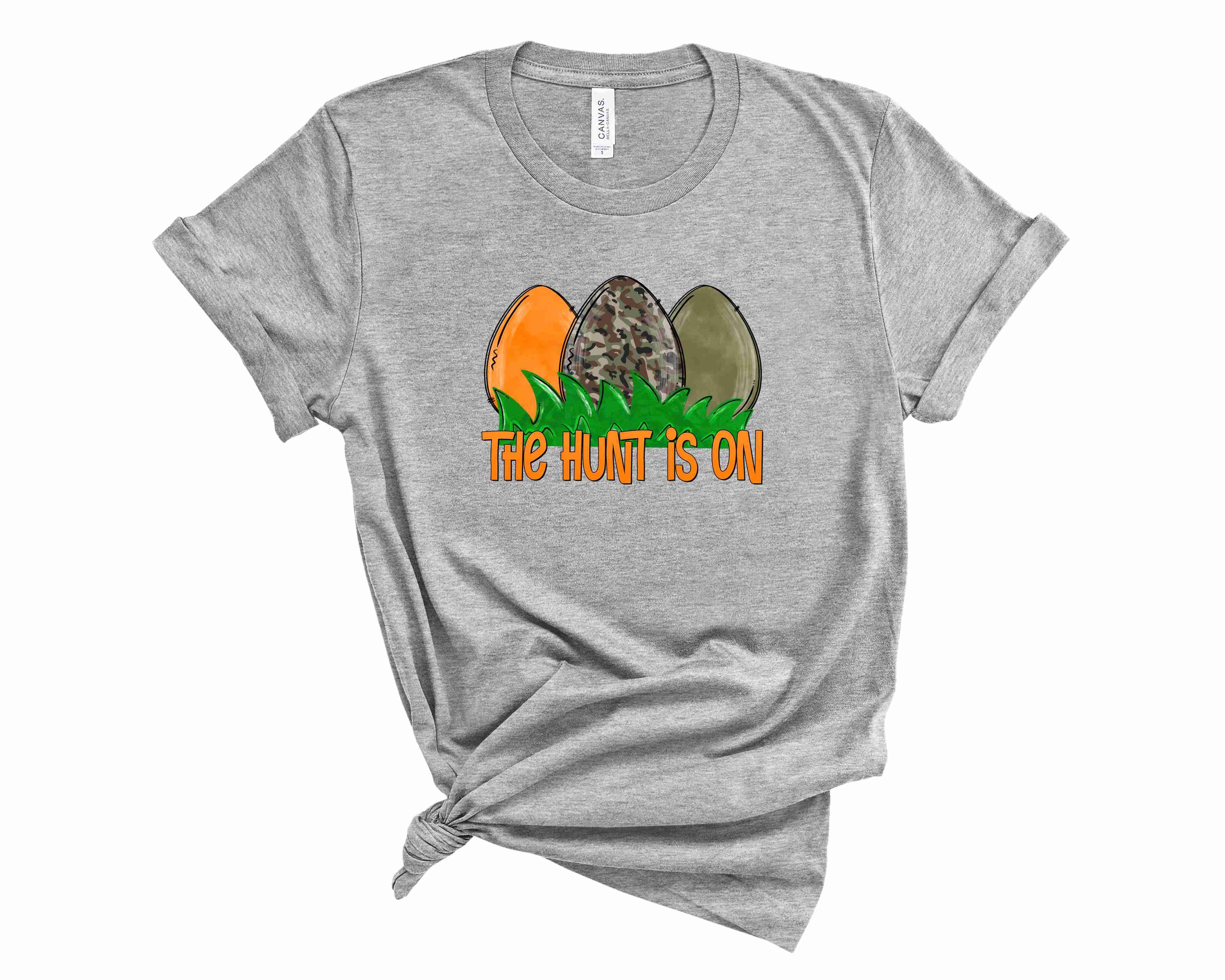 A stylish unisex camo graphic tee featuring 'The Hunt is on' design, perfect for outdoor enthusiasts.