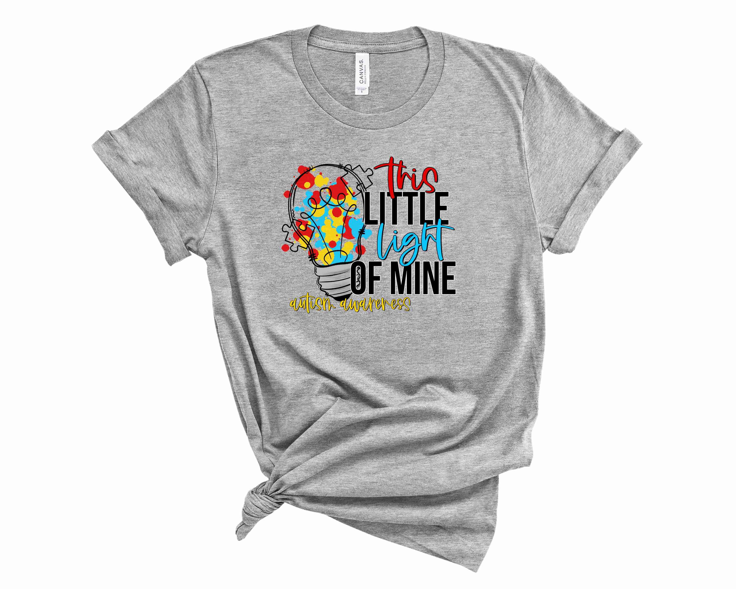 Unisex graphic tee featuring the phrase 'This Little Light of Mine' promoting autism awareness, designed for comfort and style.