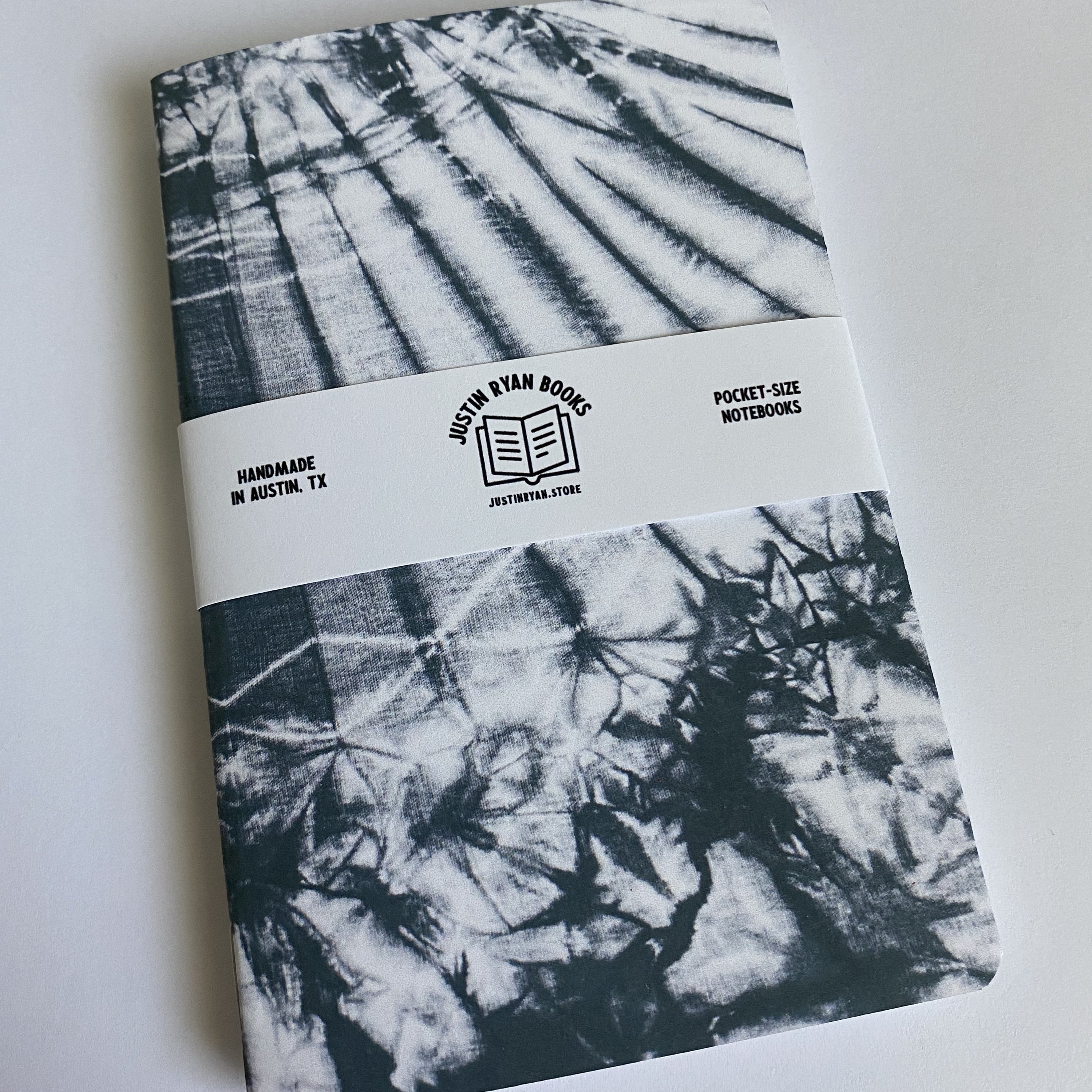 Two vibrant Tie Dye notebooks with colorful covers, showcasing various color options and inner paper styles.