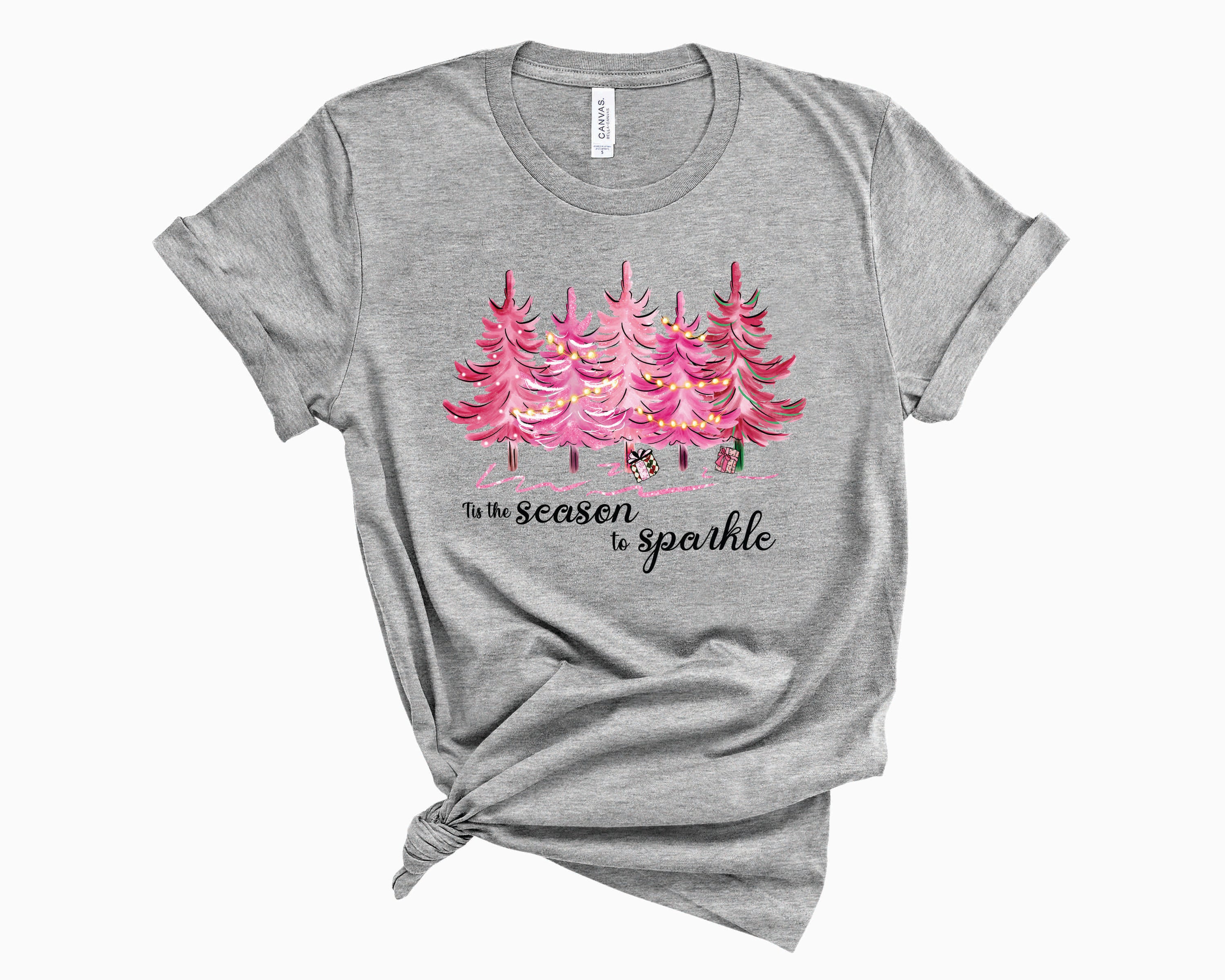 A vibrant pink unisex graphic tee featuring the phrase 'Tis The Season To Sparkle' in a festive design.