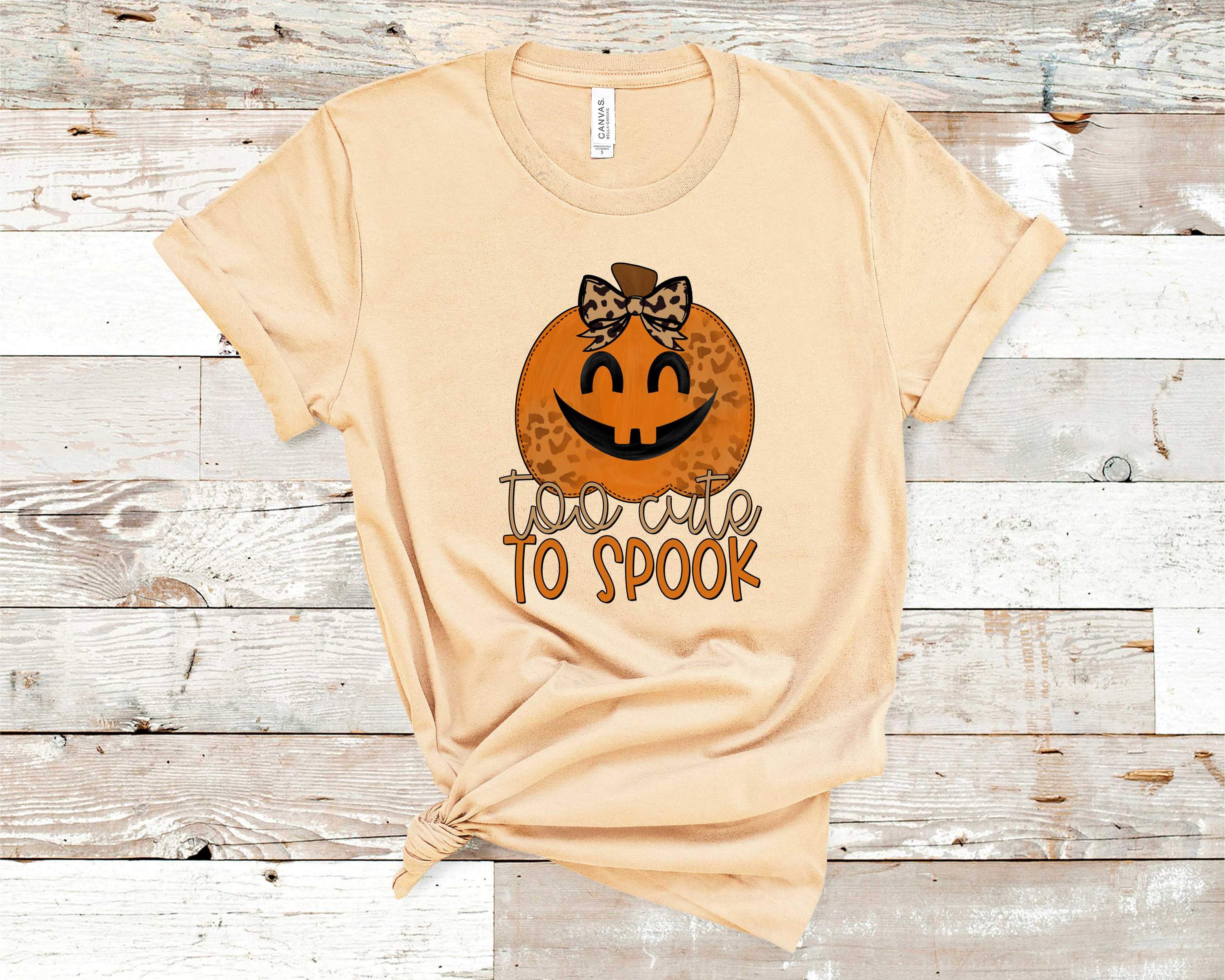 Too Cute to Spook graphic tee featuring a playful Halloween design on a soft Bella Canvas fabric.