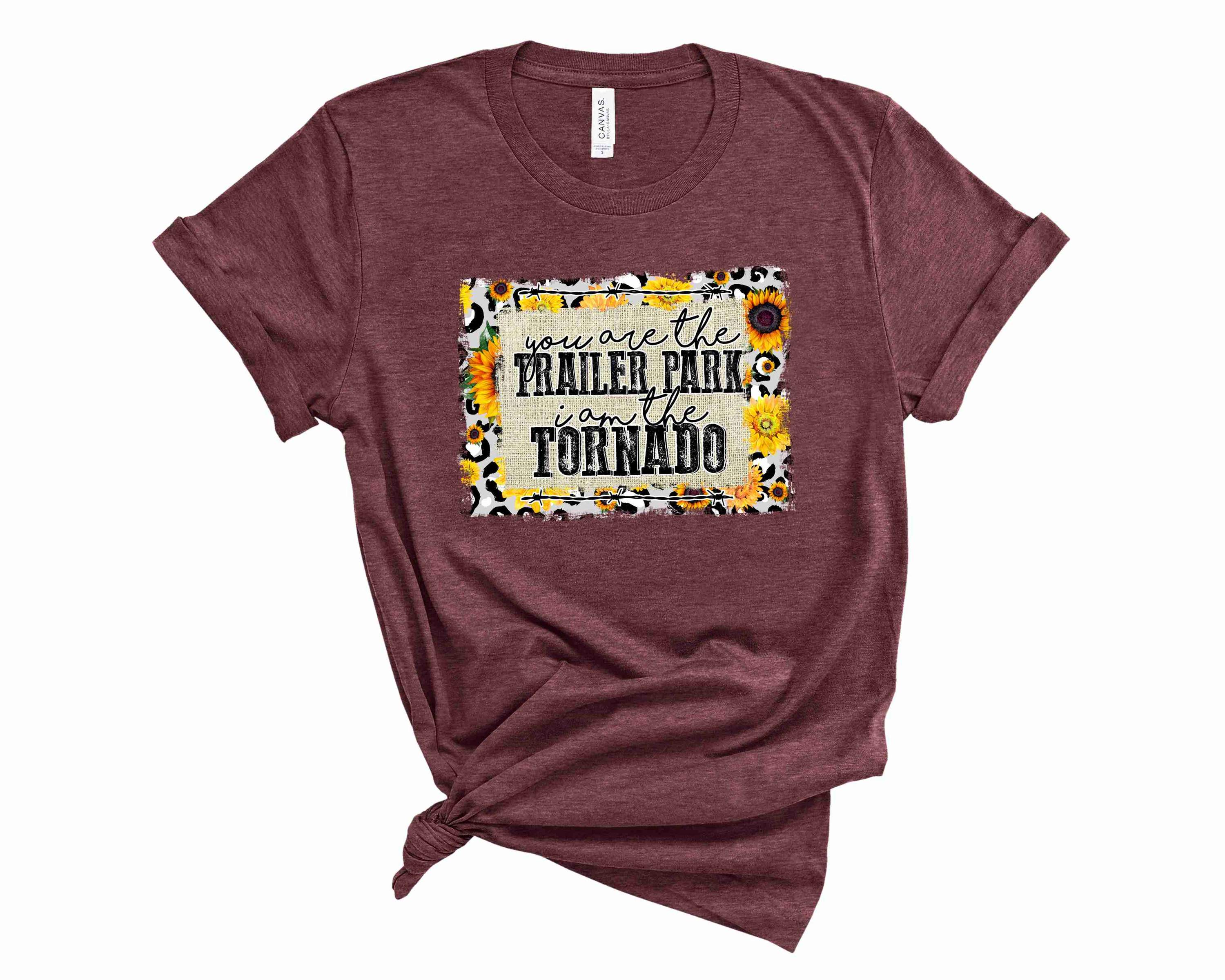 A unisex graphic tee featuring a colorful trailer park scene with a tornado, showcasing a fun and casual style.