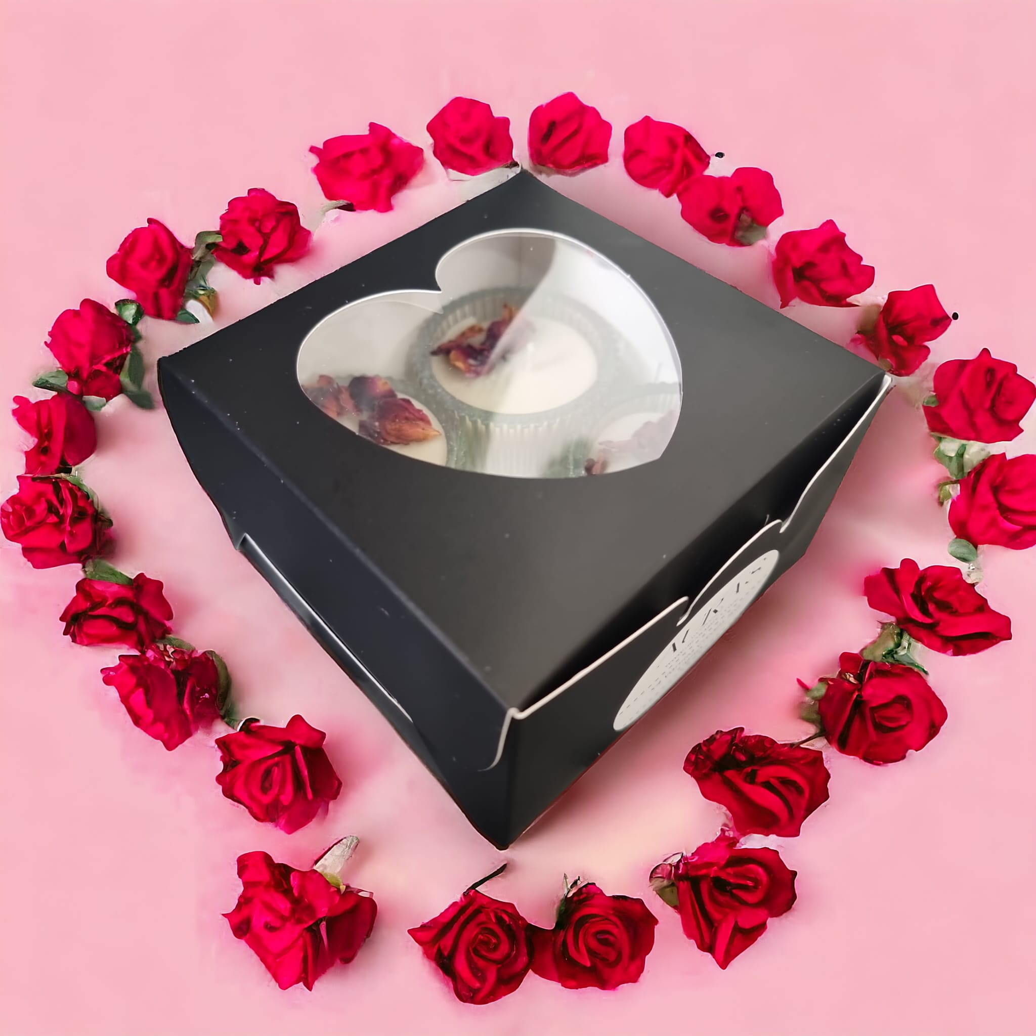 A beautifully arranged Valentine's Gift Set featuring four heart-shaped tealights in vanilla cream scent, elegantly packaged in a sleek black box.