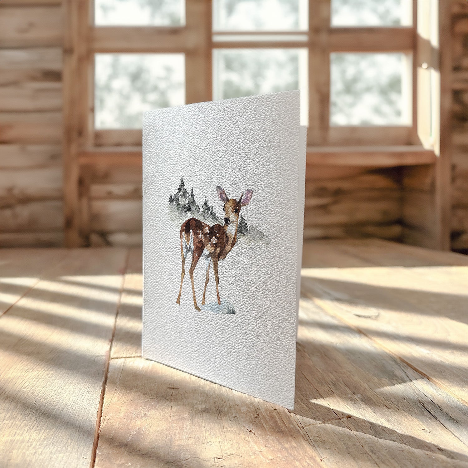 A beautifully designed greeting card featuring a watercolor illustration of a fawn, printed on high-quality cardstock.