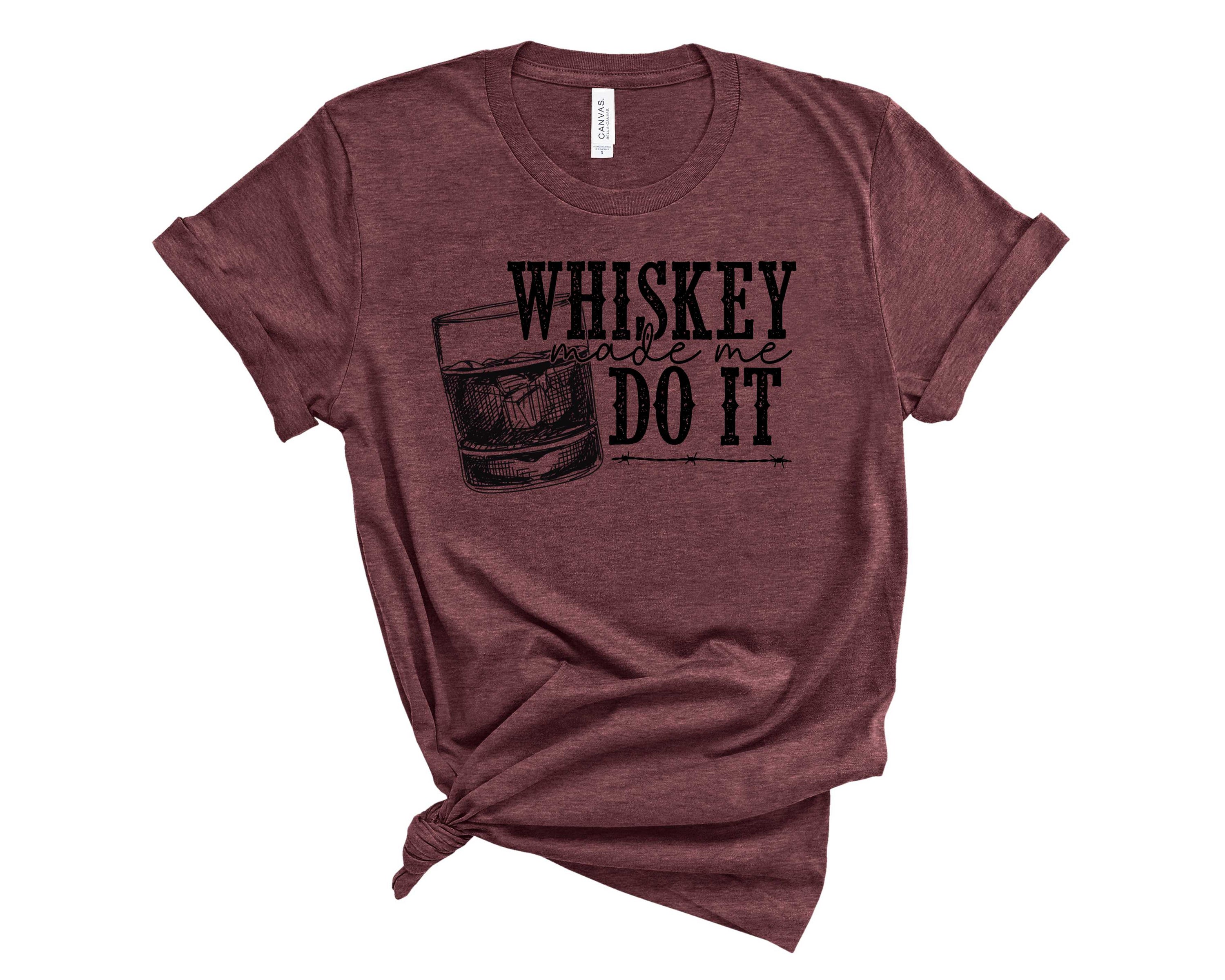 A stylish unisex graphic tee featuring the phrase 'Whiskey Made Me' in bold lettering, perfect for whiskey enthusiasts.