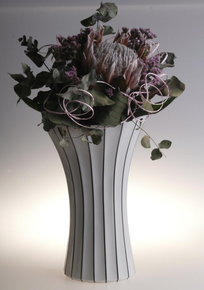 A 12-inch tall white porcelain flower vase with retro design, featuring clean lines and a glossy finish, inspired by Cubism and Art Deco styles.