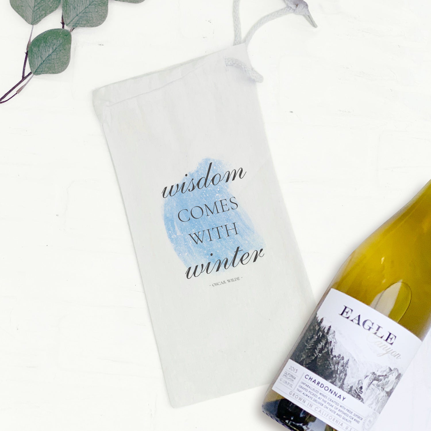 Winter Wisdom Canvas Wine Bag featuring a stylish design with a drawstring closure, perfect for holding a standard 750mL wine bottle.