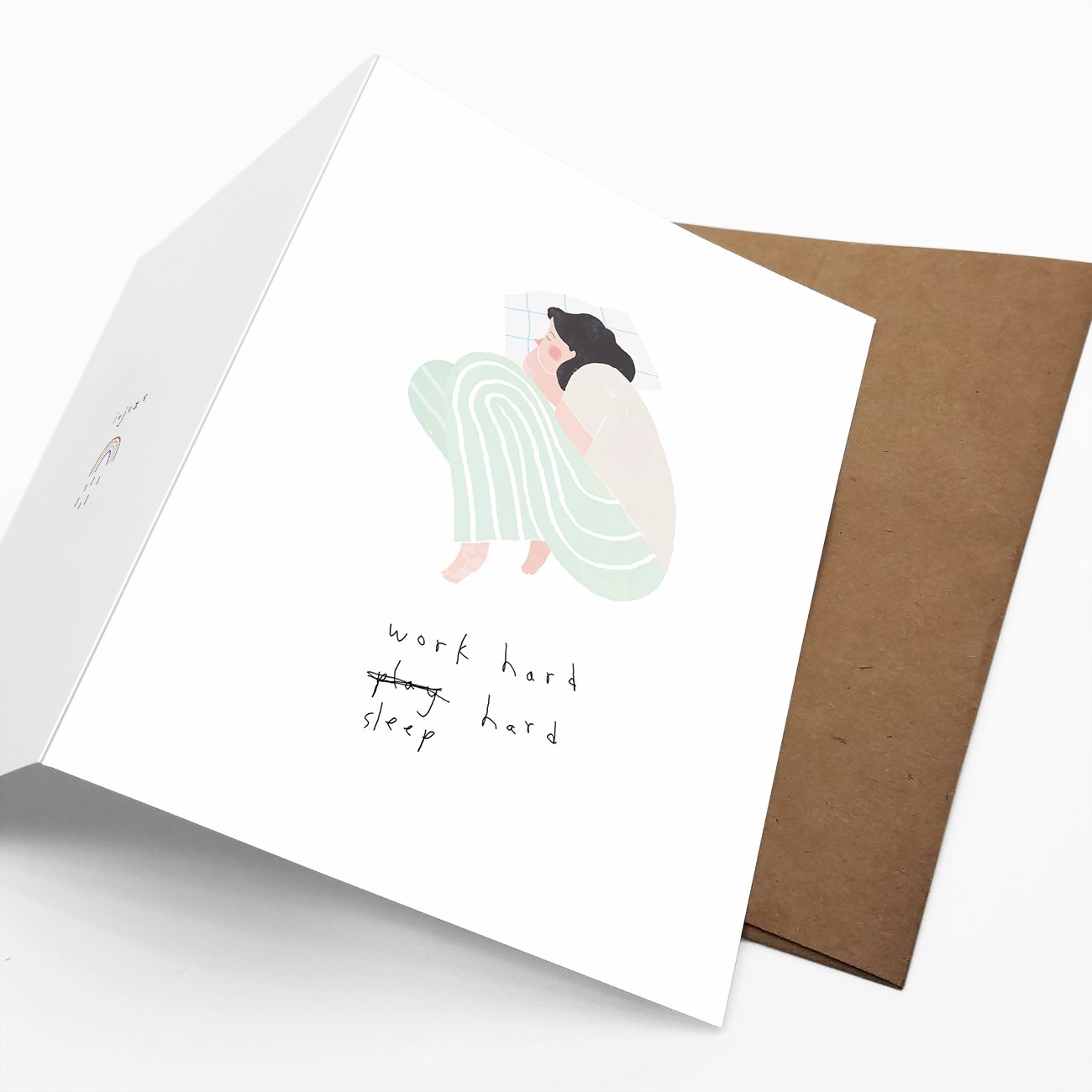 A motivational card featuring the phrase 'Work Hard, Sleep Hard' on recycled paper, displayed with a Kraft envelope.