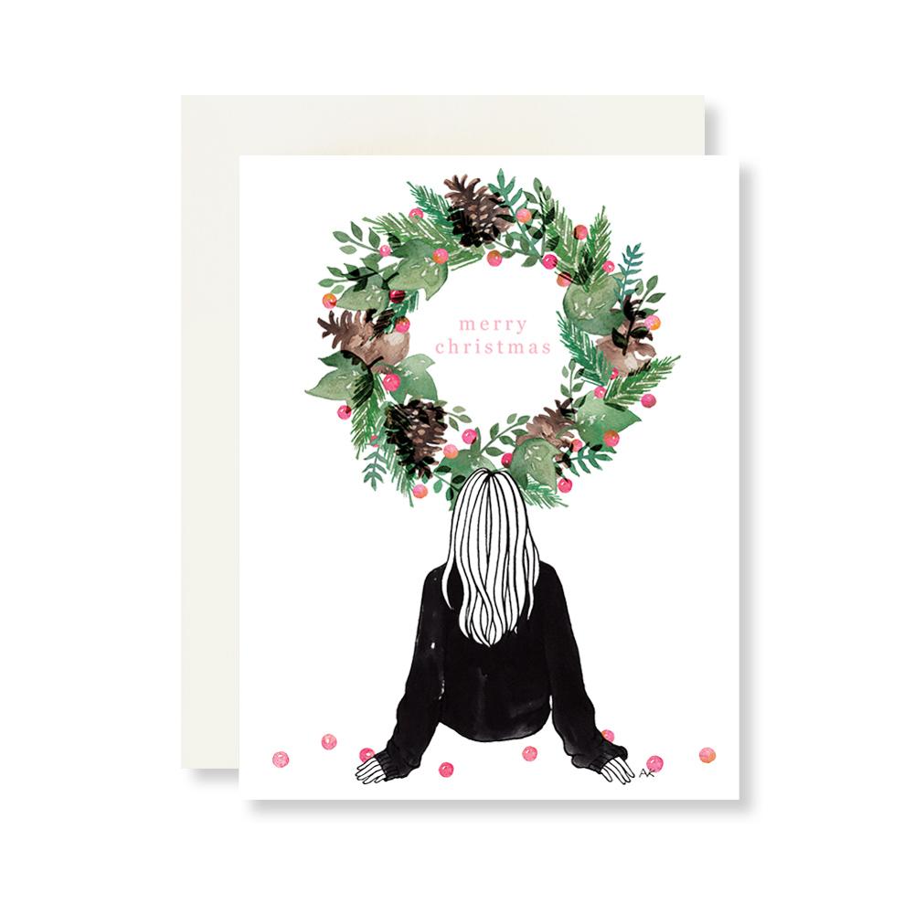 A beautifully designed boxed set of 8 Christmas cards featuring watercolor wreath illustrations, accompanied by quartz metallic envelopes.