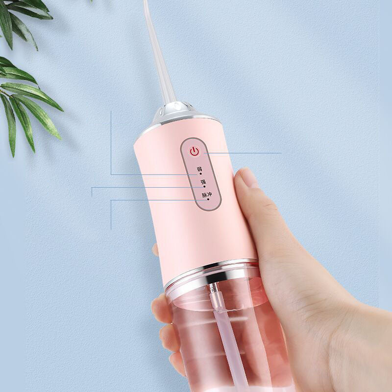 Portable 3 Modes Oral Irrigator in white, pink, and light green colors, showcasing its USB charging feature and compact design.