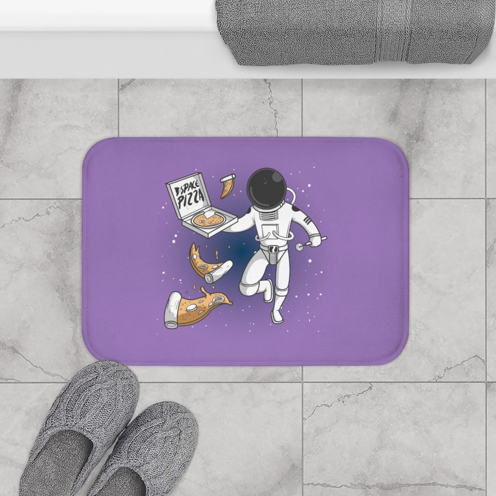 A colorful bath mat featuring an astronaut eating pizza in space, designed for safety and comfort.