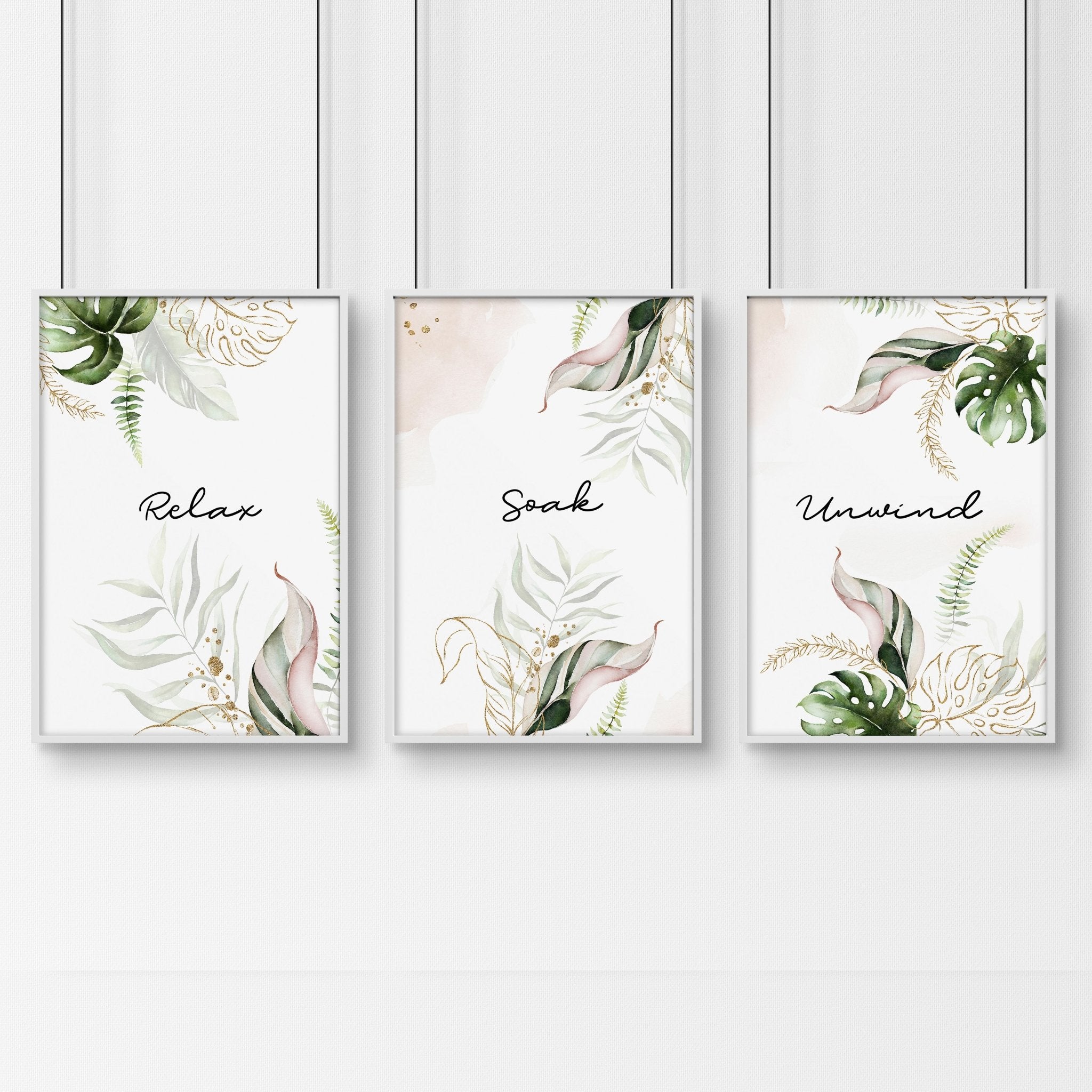 Set of 3 tropical wall art prints featuring palm leaves and exotic flowers in soft green, pink, and gold colors, perfect for bathroom decor.