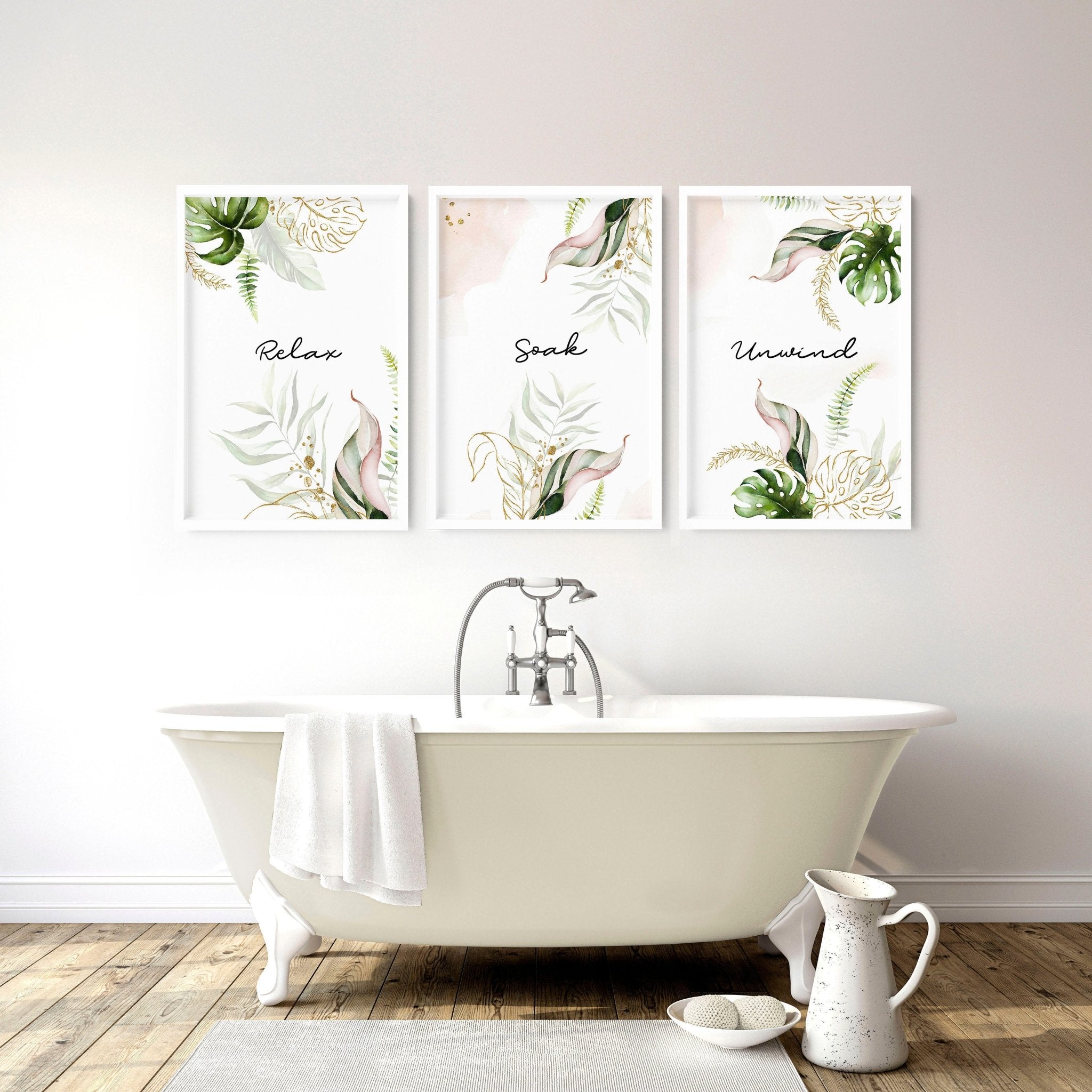 Set of 3 tropical wall art prints featuring palm leaves and exotic flowers in soft green, pink, and gold colors, perfect for bathroom decor.