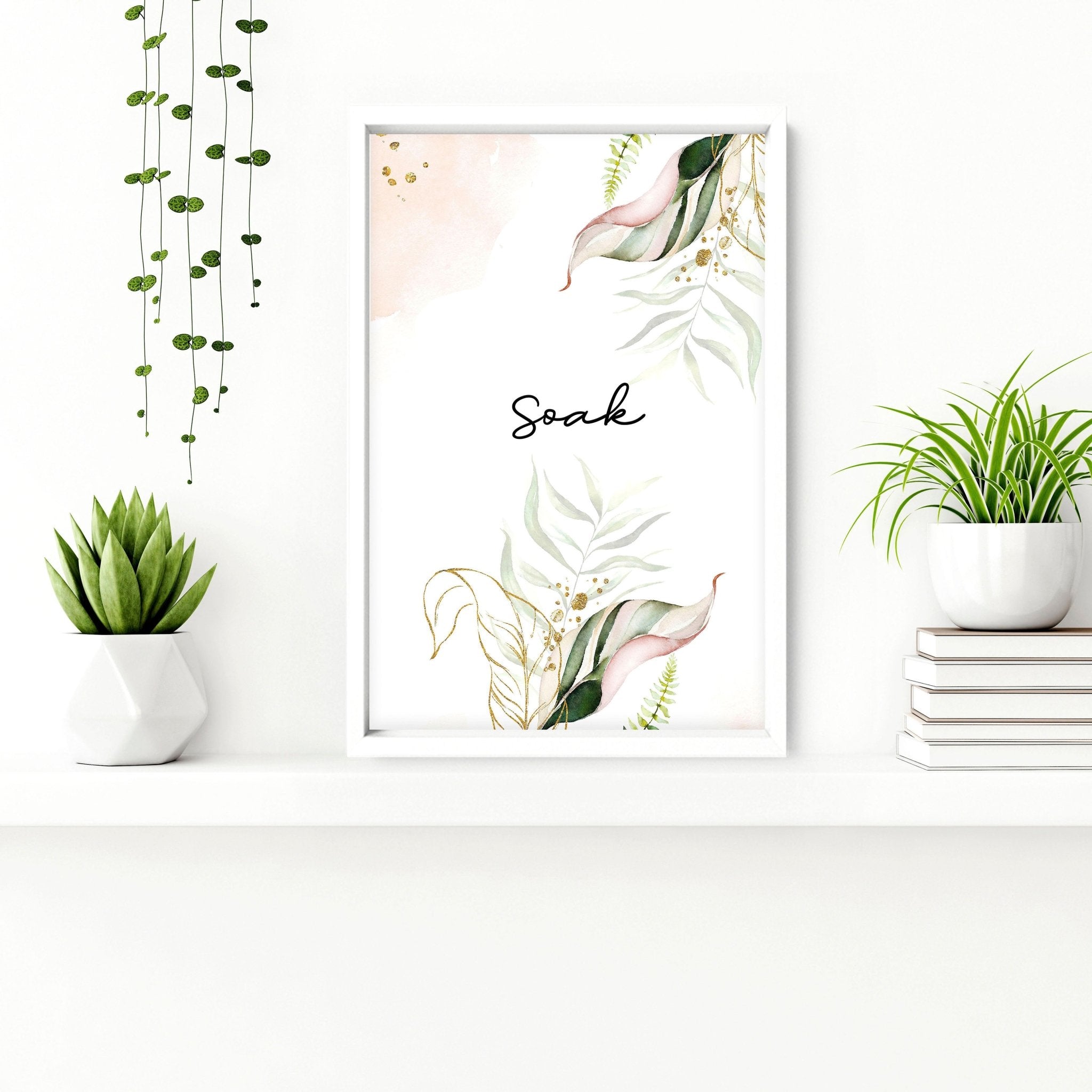 Set of 3 tropical wall art prints featuring palm leaves and exotic flowers in soft green, pink, and gold colors, perfect for bathroom decor.