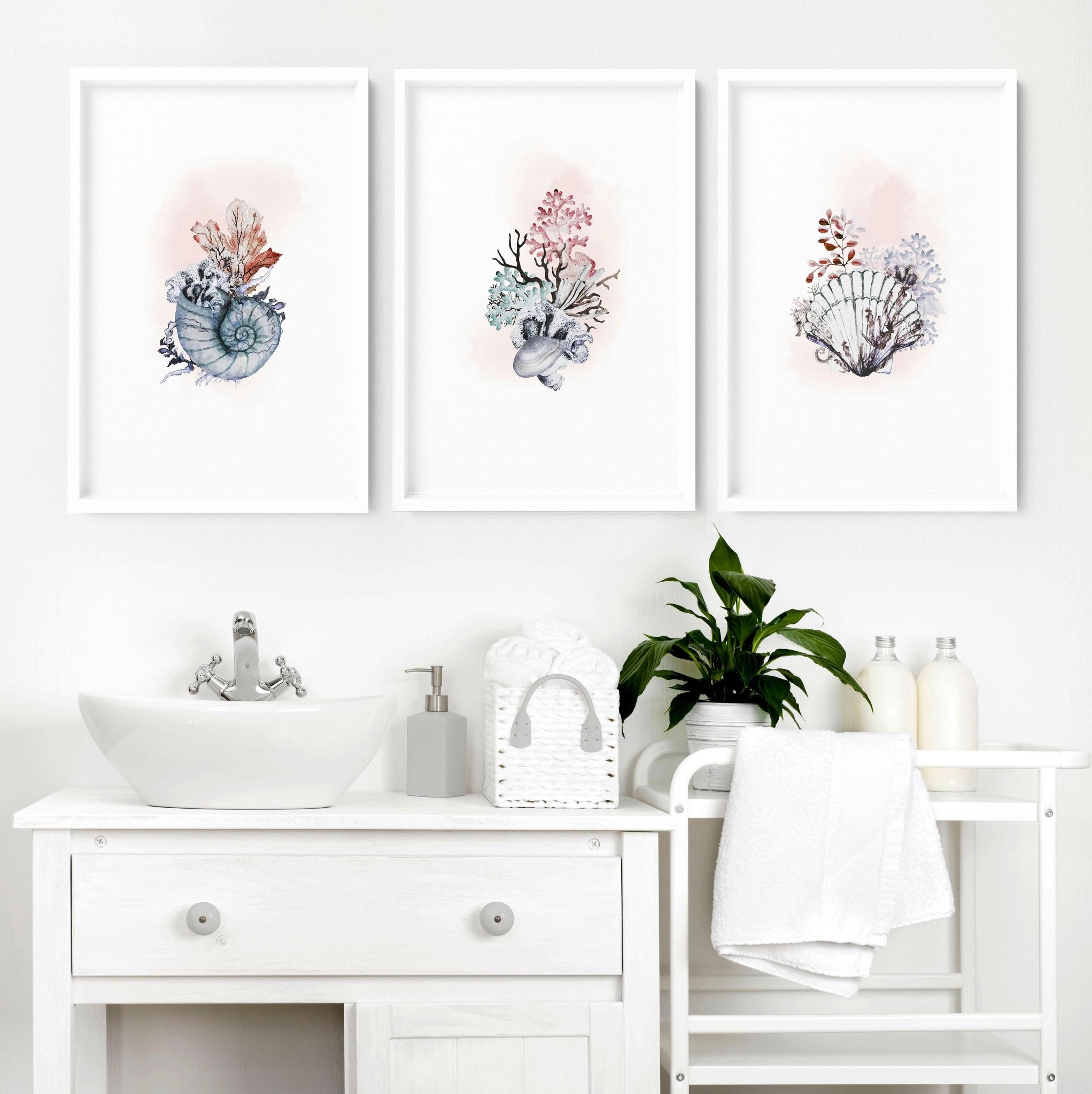 Set of 3 beach theme wall art prints featuring delicate watercolour seashells in soothing blue and blush pink tones, perfect for bathroom decor.