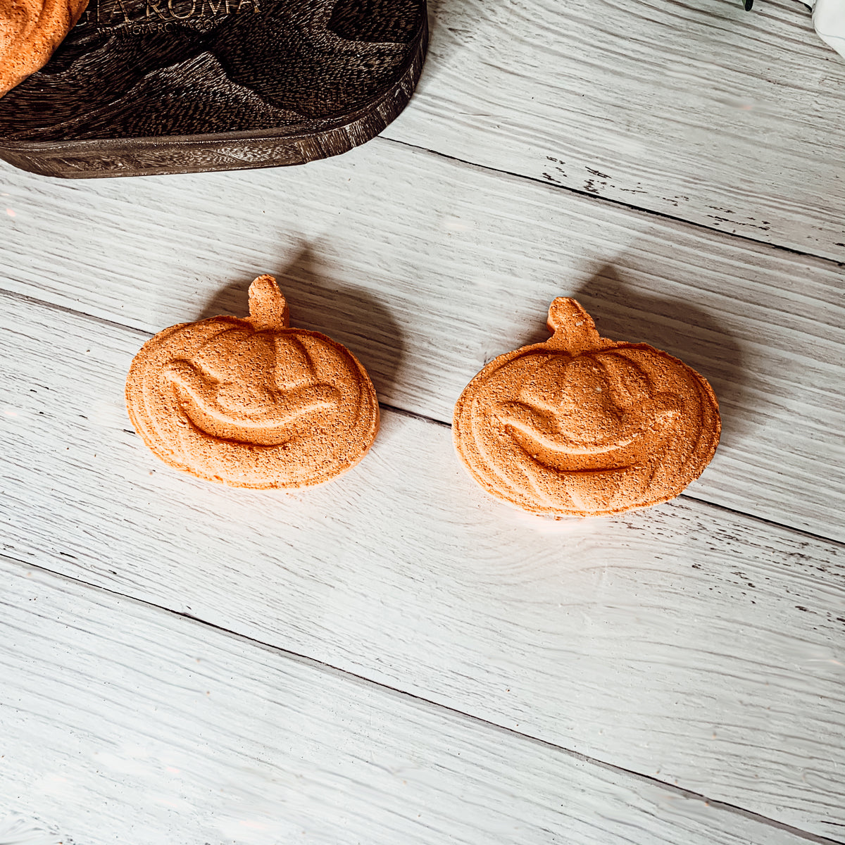 A vibrant Pumpkin Spice Bath Bomb, 3.5oz, featuring warm orange hues and a decorative design, perfect for fall-themed self-care.