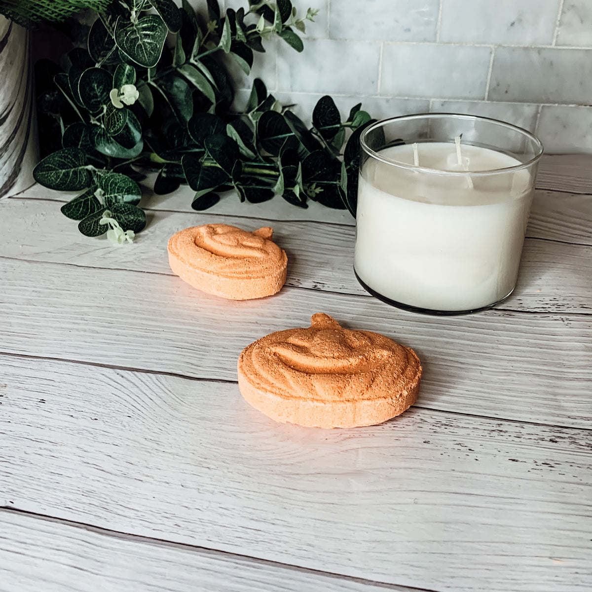A vibrant Pumpkin Spice Bath Bomb, 3.5oz, featuring warm orange hues and a decorative design, perfect for fall-themed self-care.