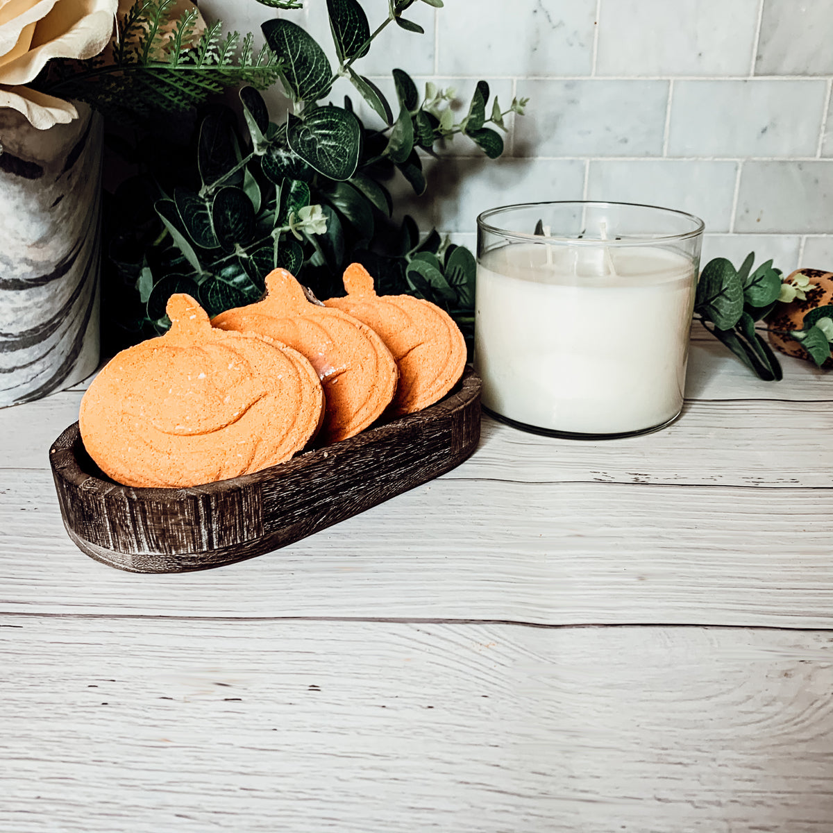 A vibrant Pumpkin Spice Bath Bomb, 3.5oz, featuring warm orange hues and a decorative design, perfect for fall-themed self-care.