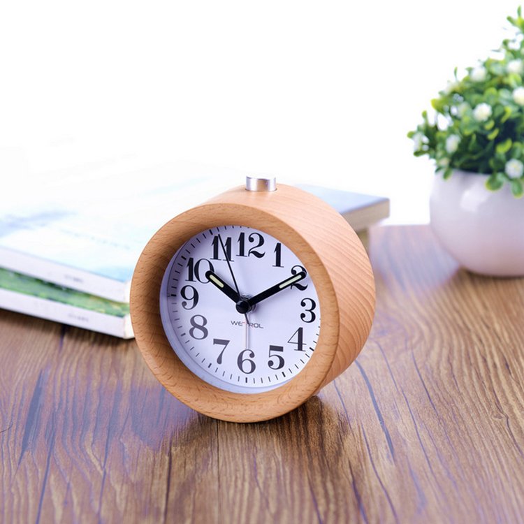 A stylish Wooden LED Alarm Clock made of beech wood, featuring a gradual alarm sound and warm LED light, perfect for bedside use.