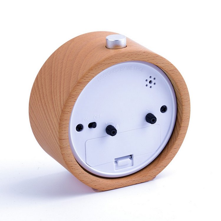 A stylish Wooden LED Alarm Clock made of beech wood, featuring a gradual alarm sound and warm LED light, perfect for bedside use.