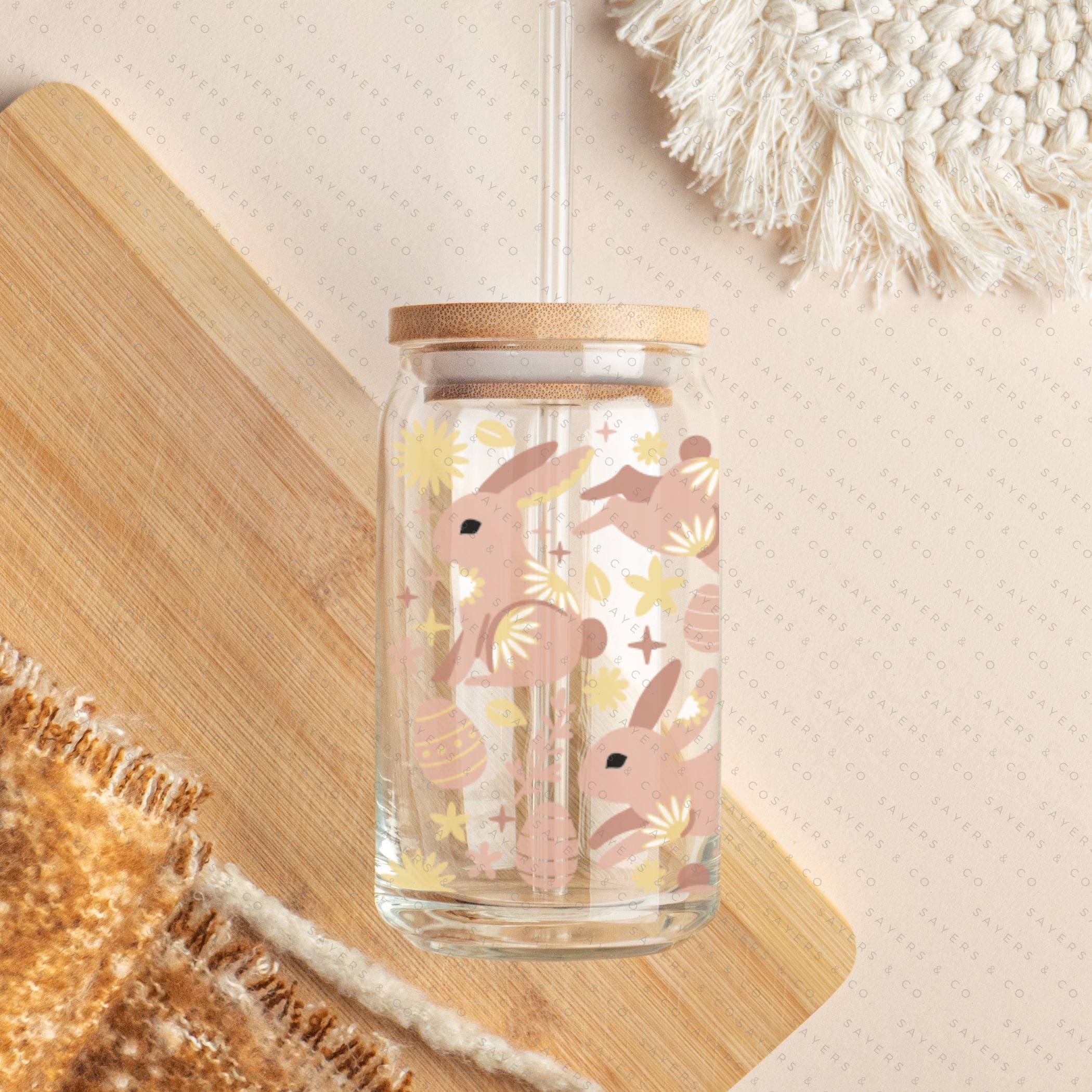 16oz Easter Blissful Bunnies Glass Cup with bamboo lid and straw, featuring a whimsical bunny design, perfect for drinks.