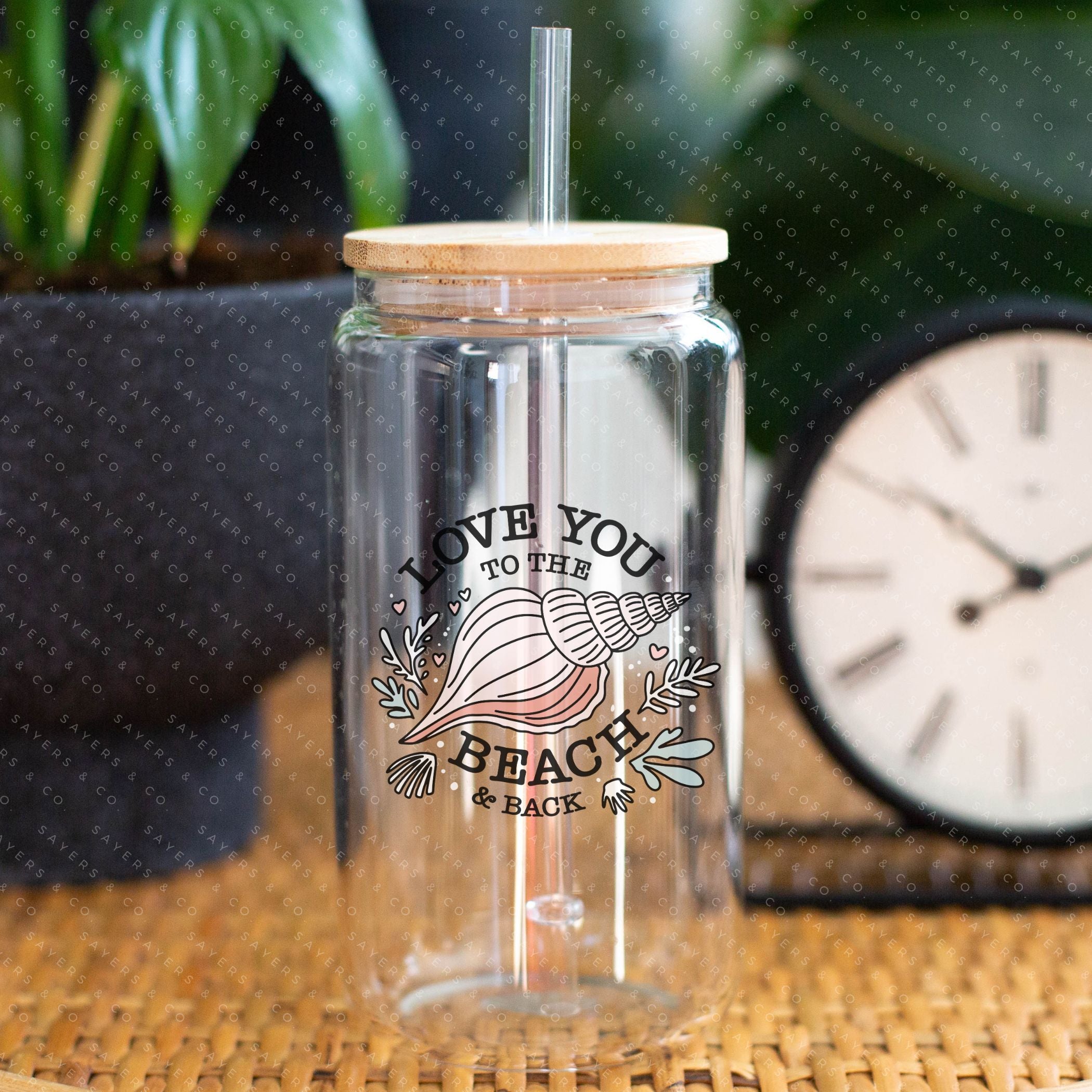 16oz Love You to the Beach Glass Cup with bamboo lid and straw, showcasing a floral design perfect for summer drinks.