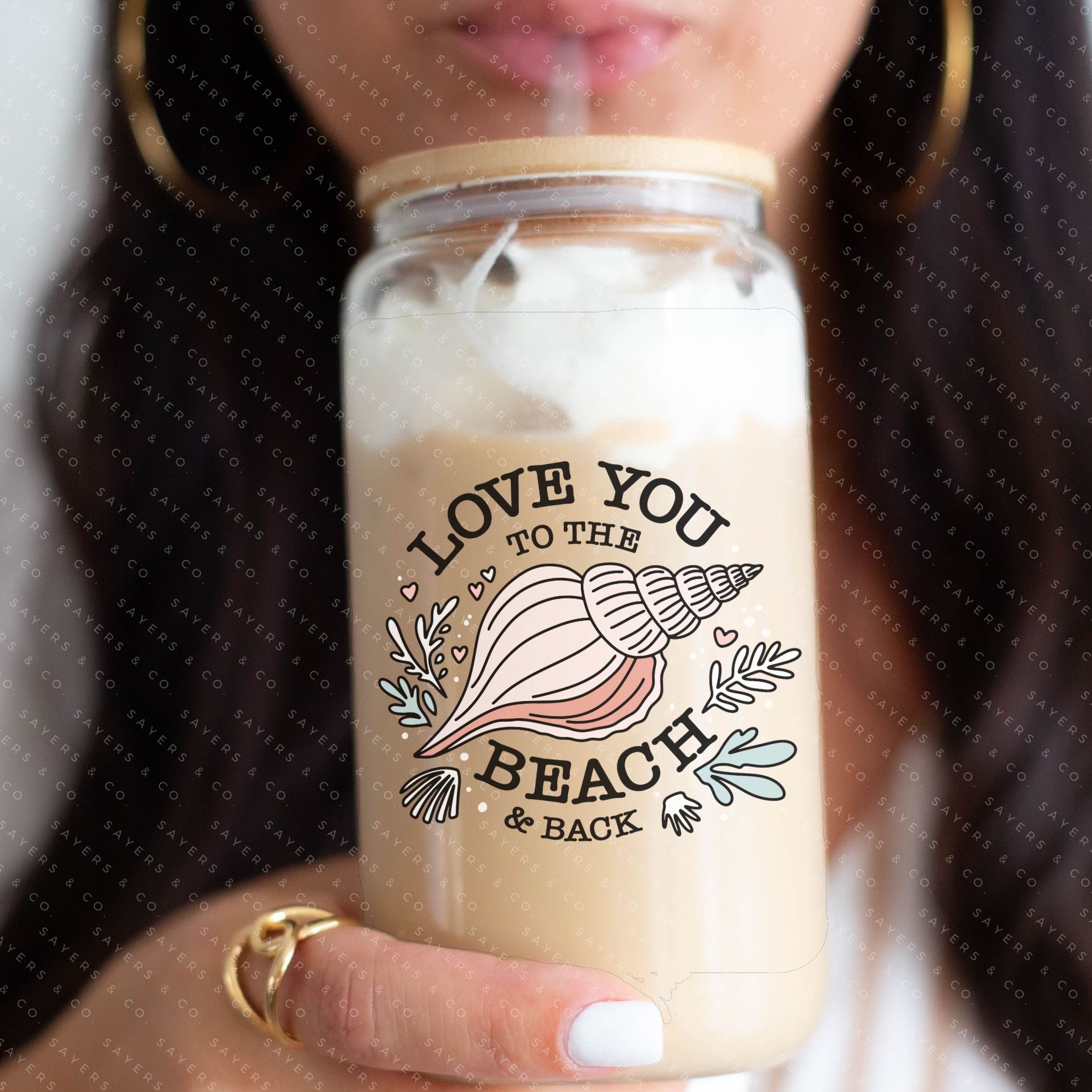 16oz Love You to the Beach Glass Cup with bamboo lid and straw, showcasing a floral design perfect for summer drinks.