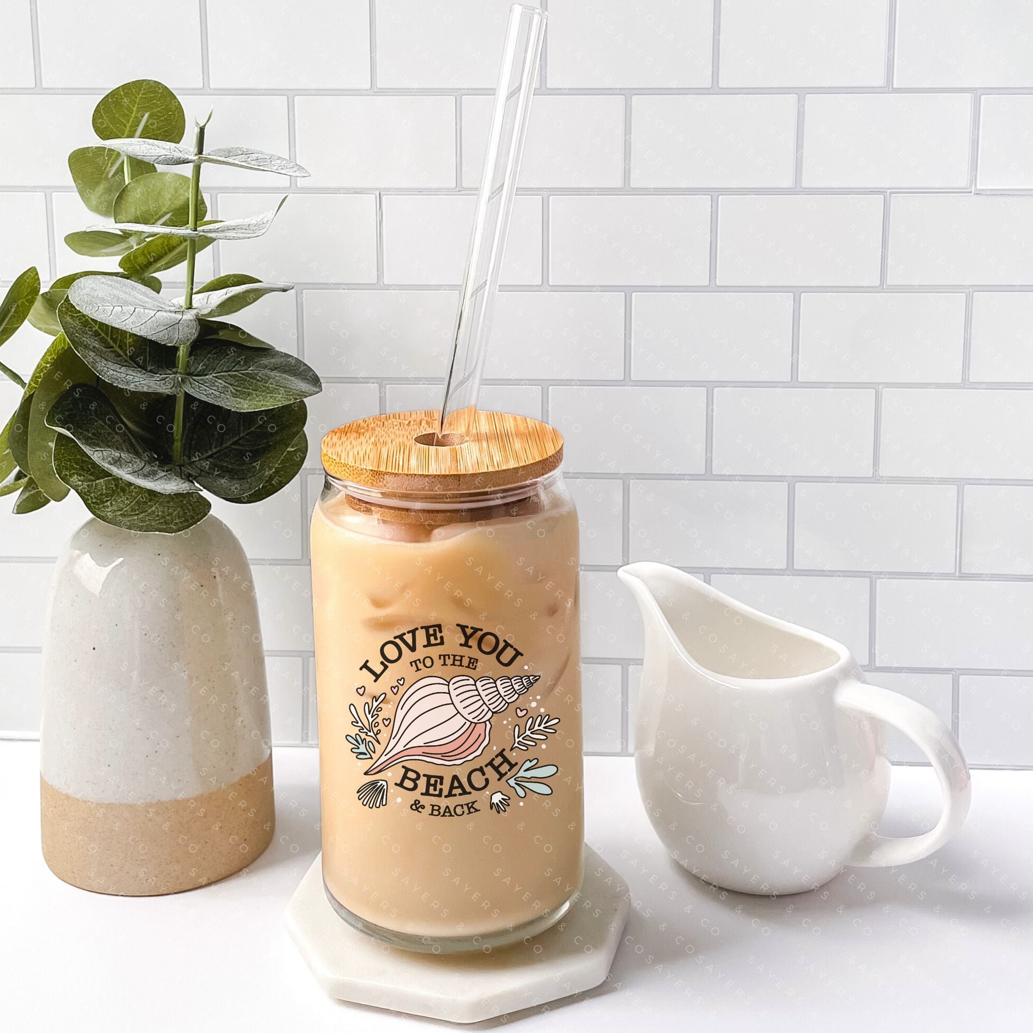 16oz Love You to the Beach Glass Cup with bamboo lid and straw, showcasing a floral design perfect for summer drinks.