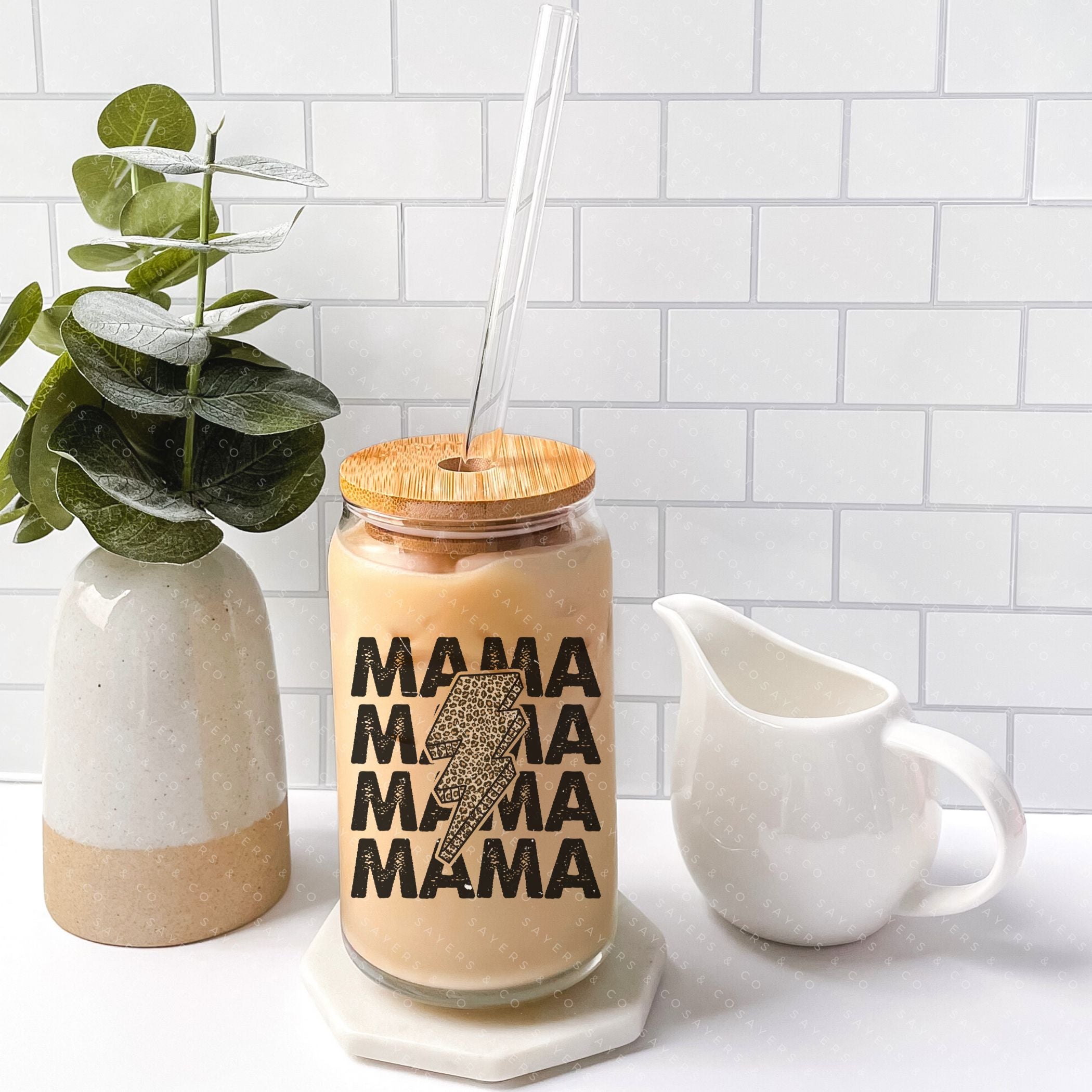 16oz Mama Leopard Bolt Glass Cup with bamboo lid and straw, featuring a stylish leopard design, perfect for drinks.