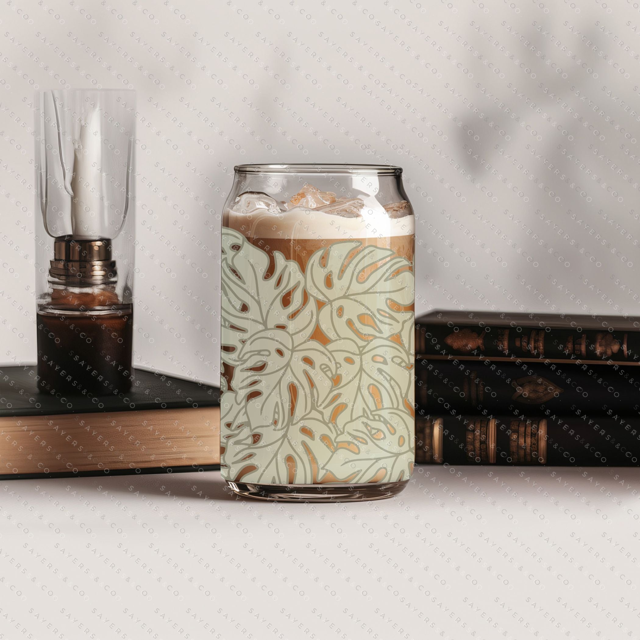 16oz Monstera Jungle Glass Cup with bamboo lid and straw, featuring a vibrant tropical design.