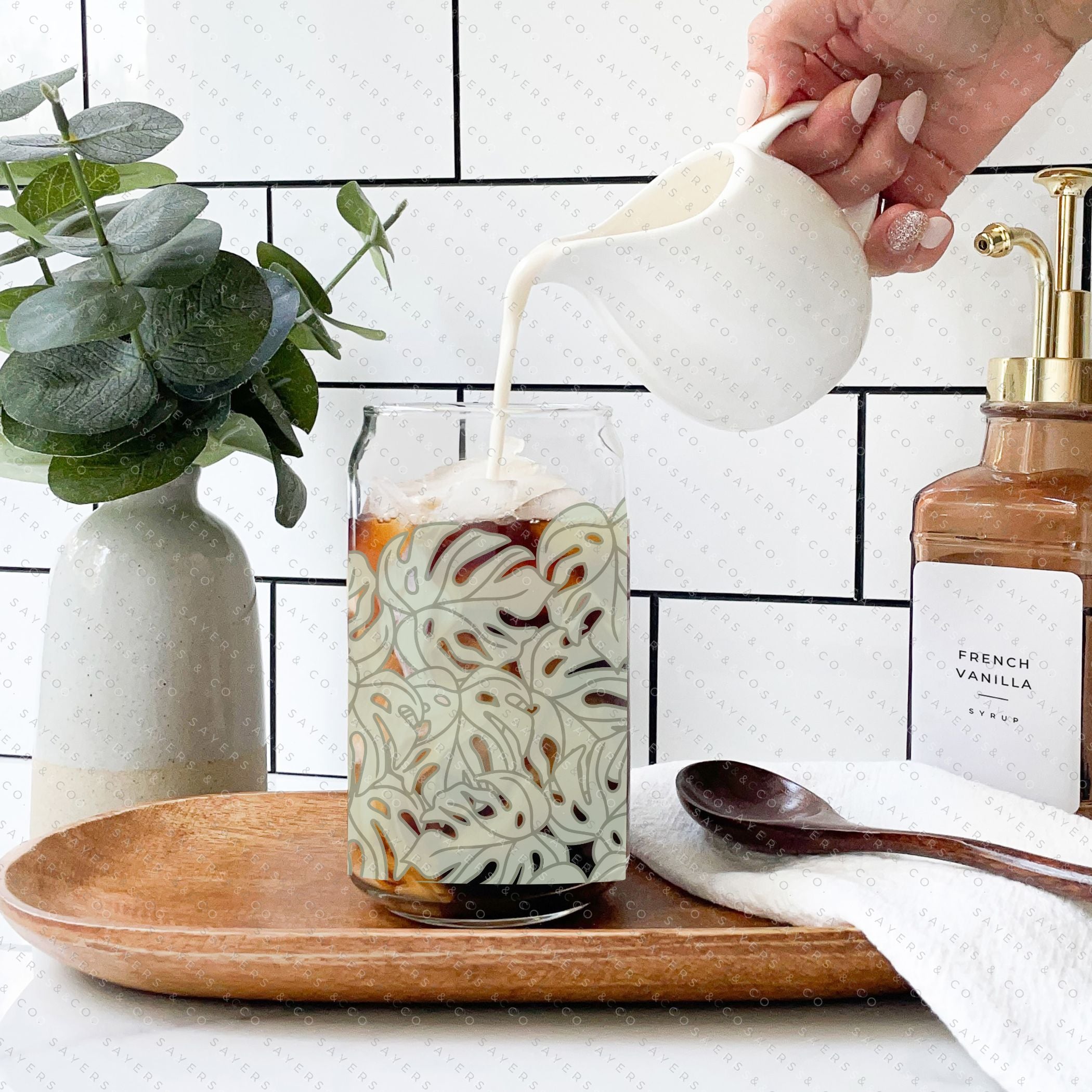 16oz Monstera Jungle Glass Cup with bamboo lid and straw, featuring a vibrant tropical design.