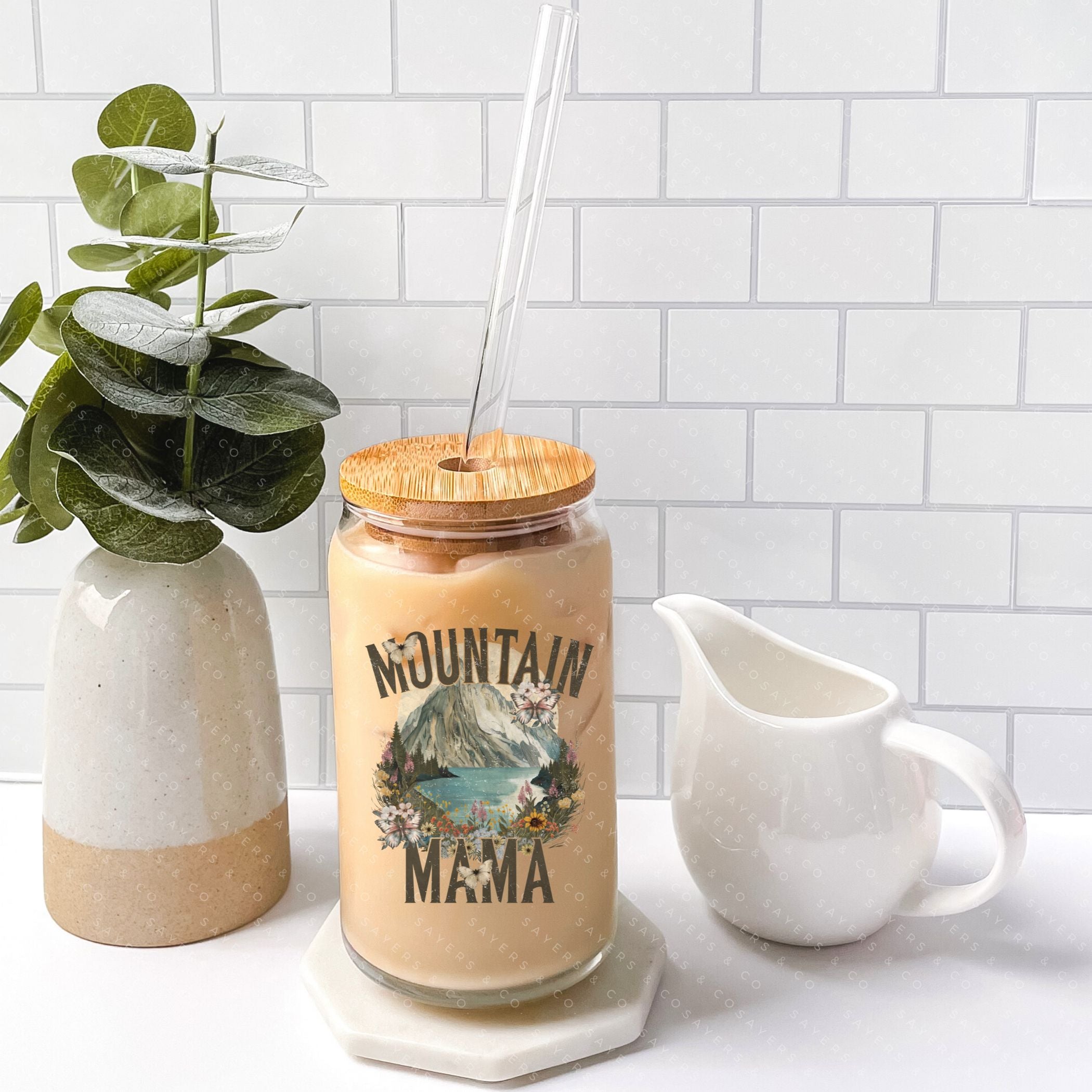 16oz Mountain Mama Glass Cup with Bamboo Lid and Straw, showcasing a clear glass design with a bamboo lid and a clear straw, perfect for beverages.