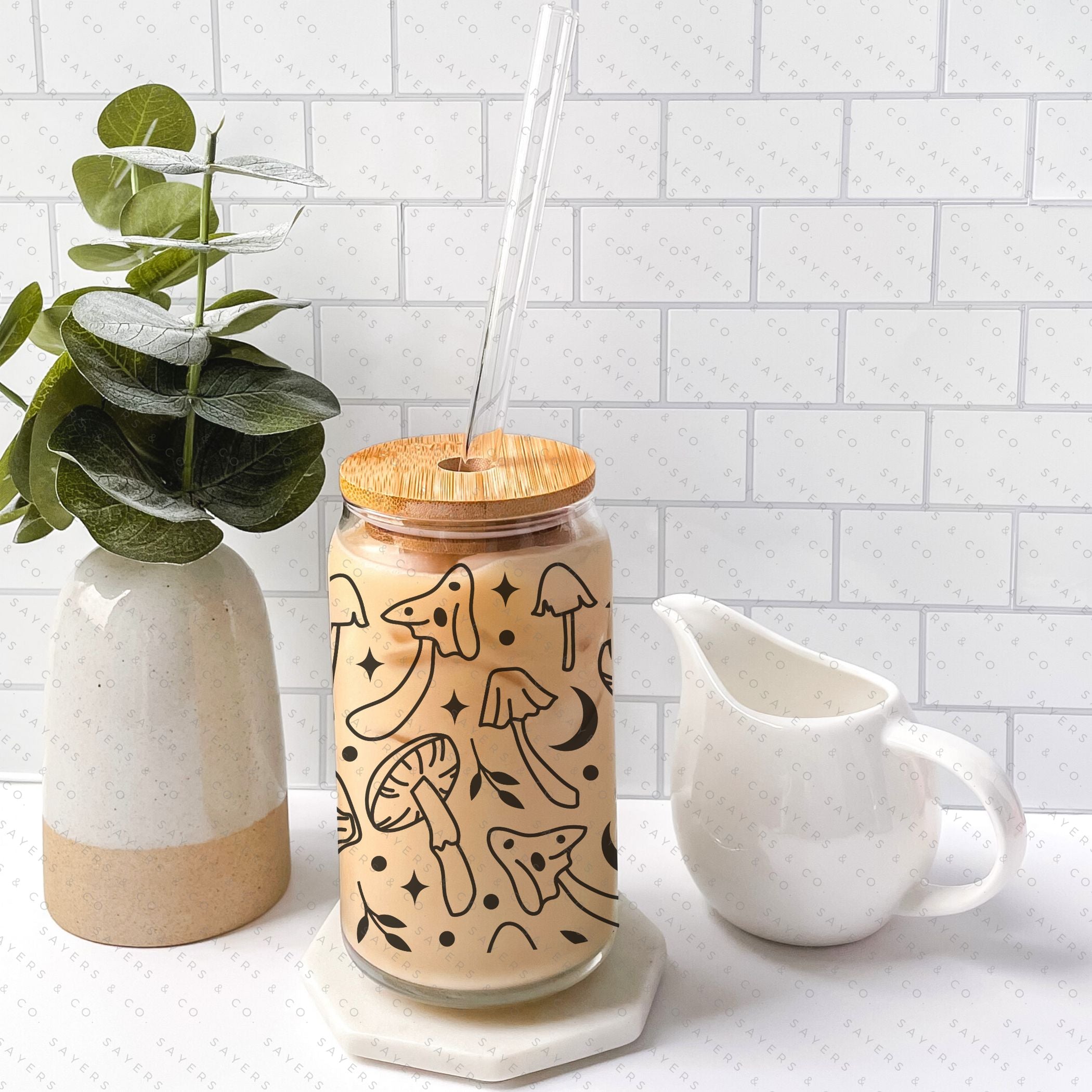16oz Mushroom Magik Glass Cup with bamboo lid and straw, featuring a whimsical mushroom design, perfect for various beverages.
