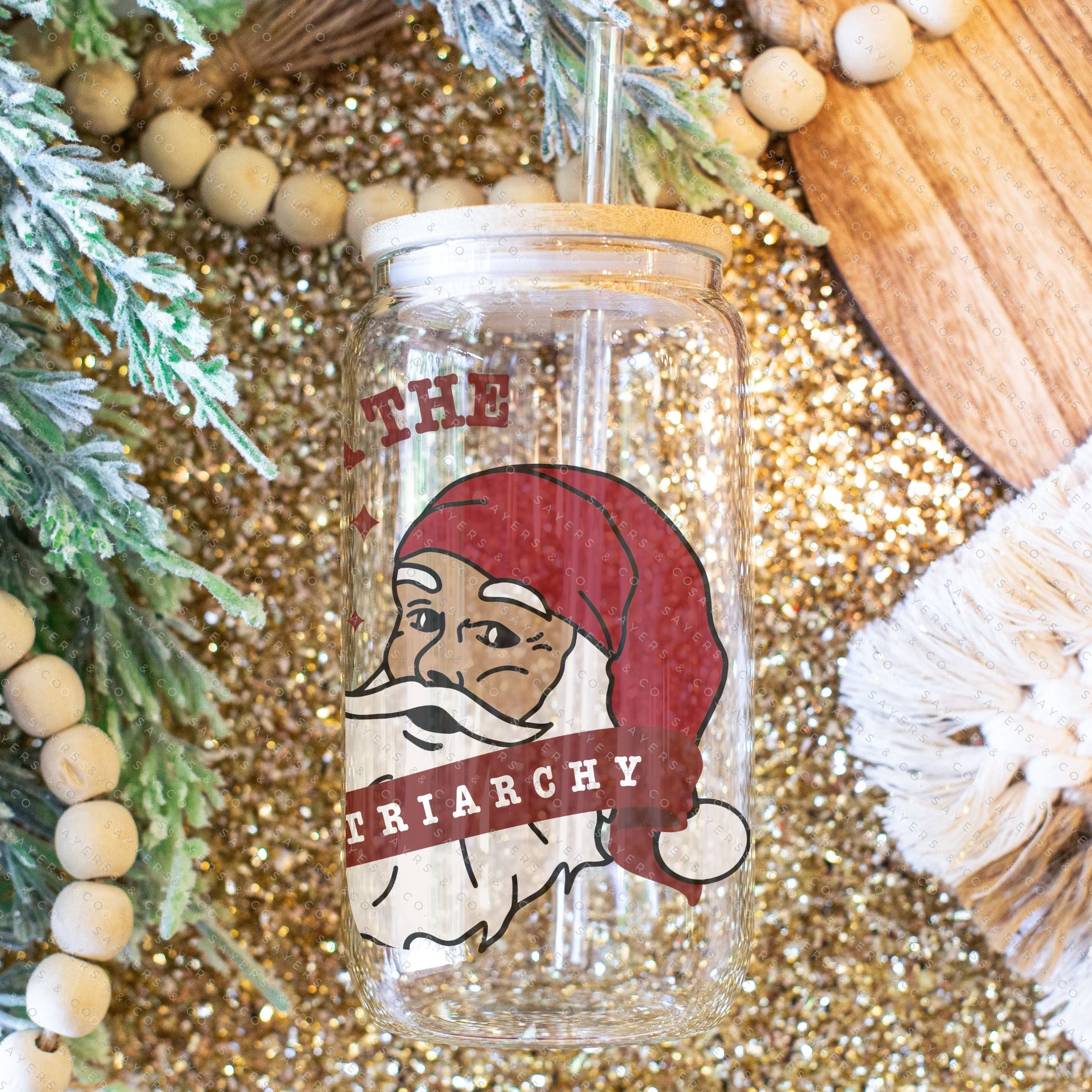 16oz Sleigh The Patriarchy Glass Cup with bamboo lid and straw, showcasing a fun design perfect for beverages.