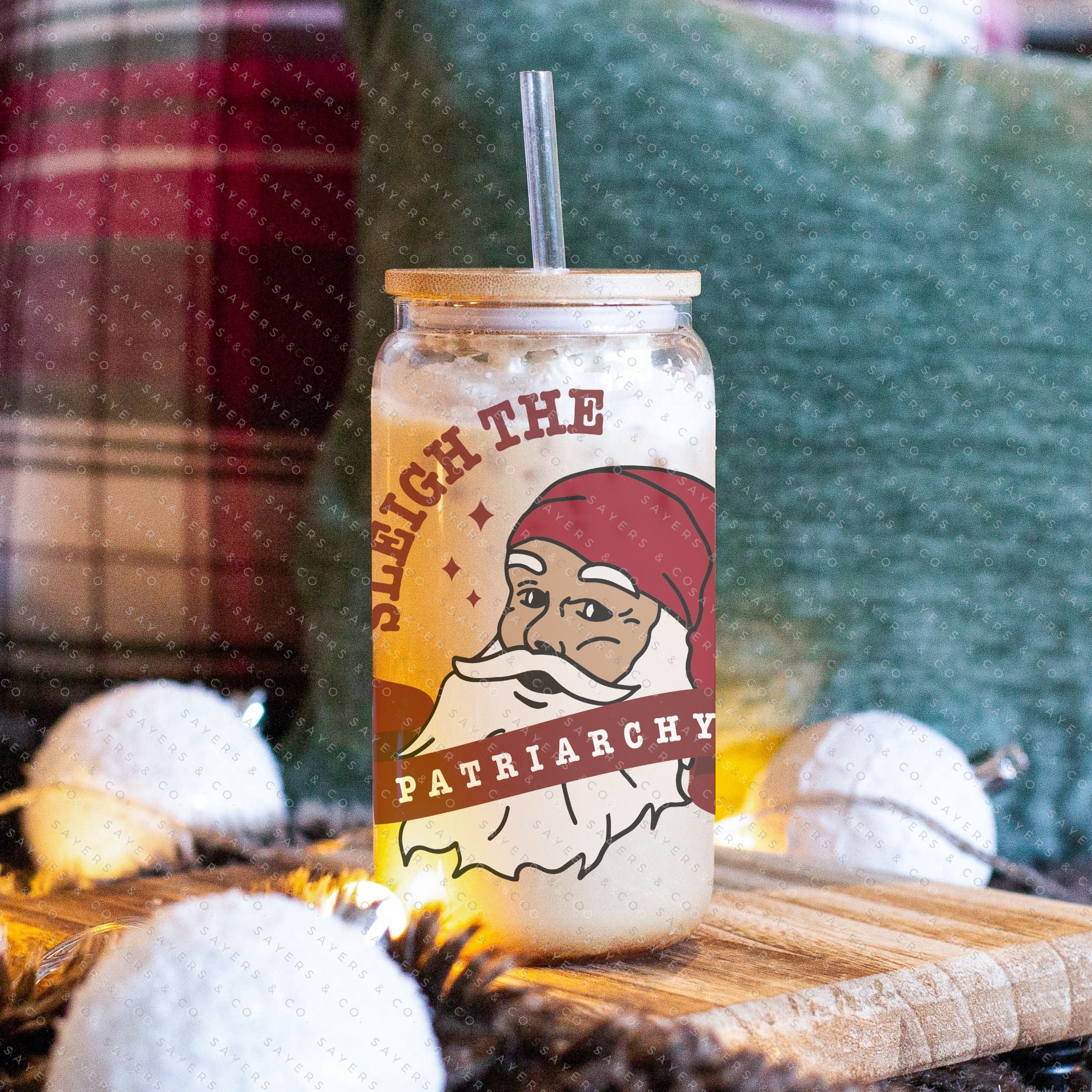 16oz Sleigh The Patriarchy Glass Cup with bamboo lid and straw, showcasing a fun design perfect for beverages.