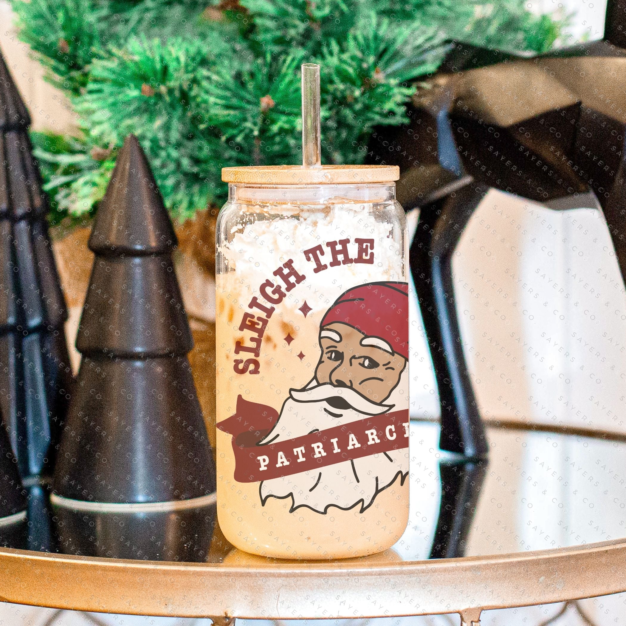 16oz Sleigh The Patriarchy Glass Cup with bamboo lid and straw, showcasing a fun design perfect for beverages.