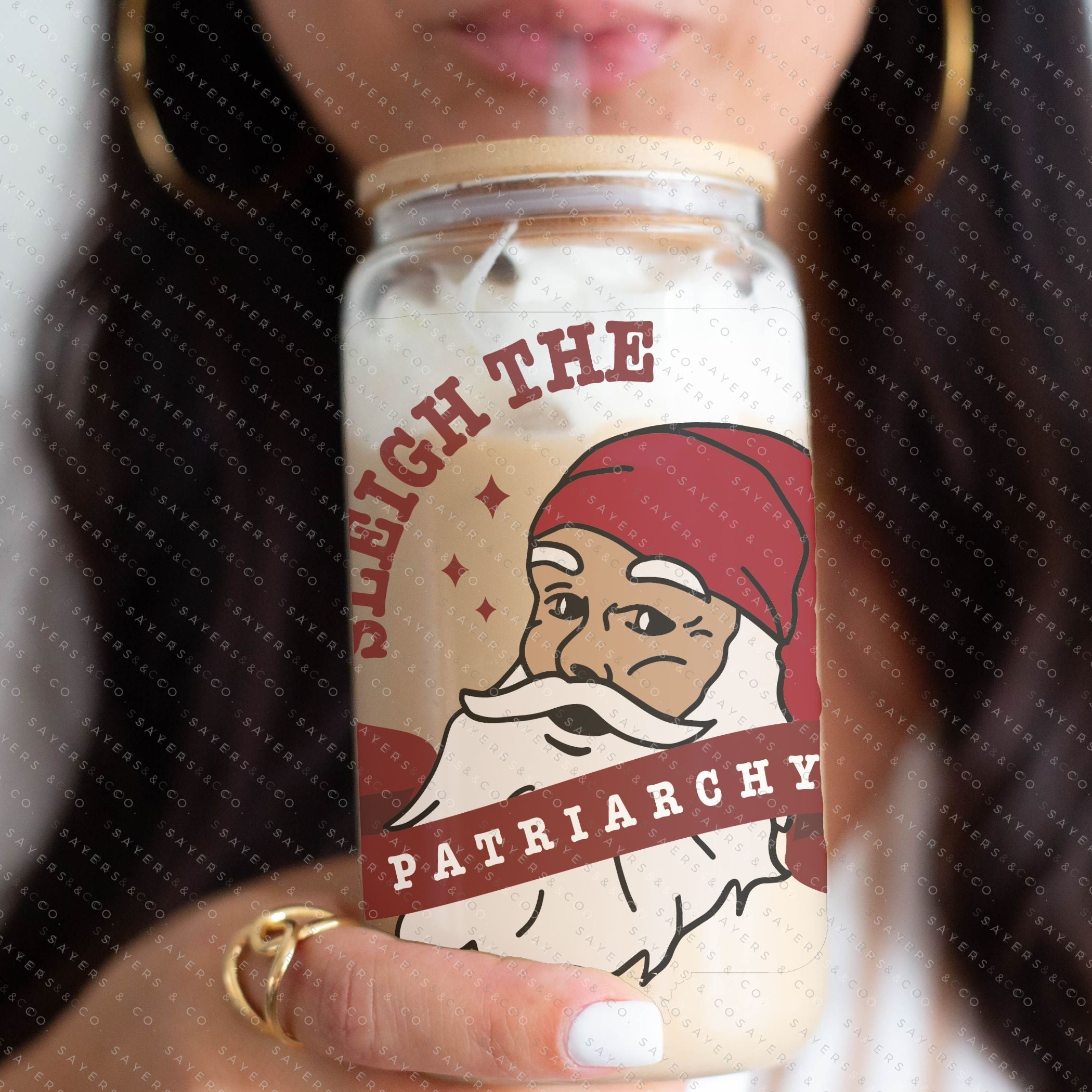 16oz Sleigh The Patriarchy Glass Cup with bamboo lid and straw, showcasing a fun design perfect for beverages.