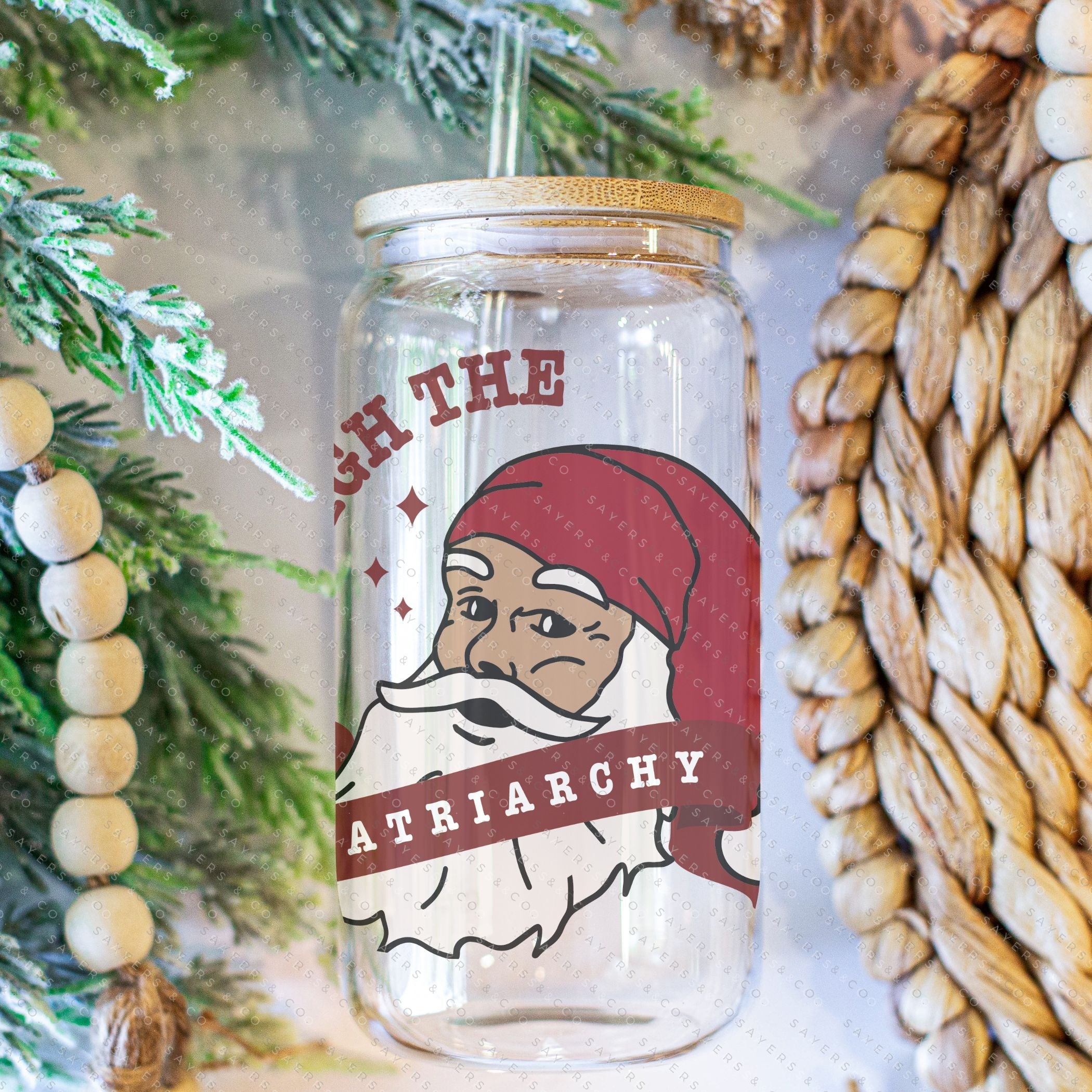 16oz Sleigh The Patriarchy Glass Cup with bamboo lid and straw, showcasing a fun design perfect for beverages.