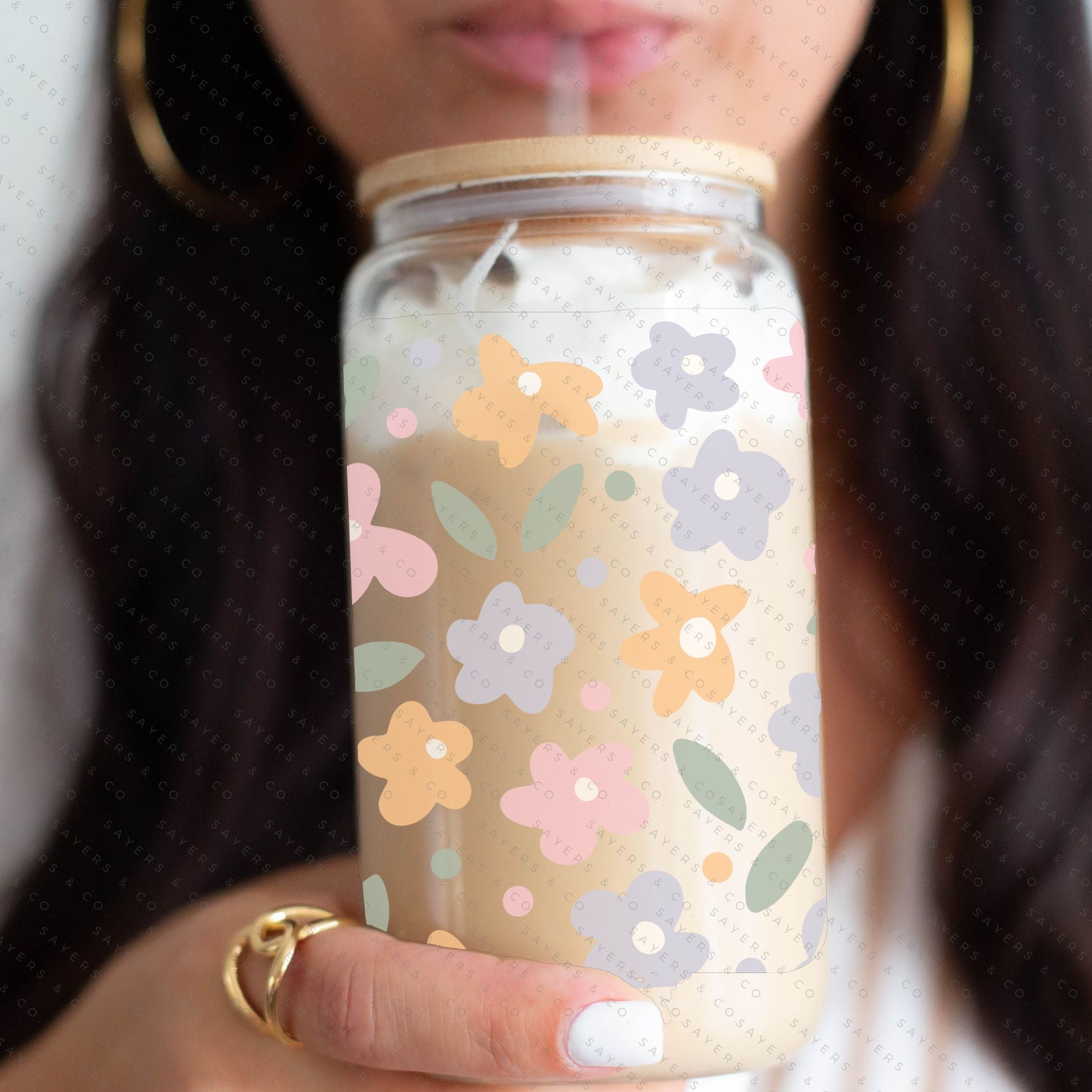 16oz Spring Pastel Petals Glass Cup featuring a bamboo lid and straw, adorned with colorful floral designs, perfect for beverages.