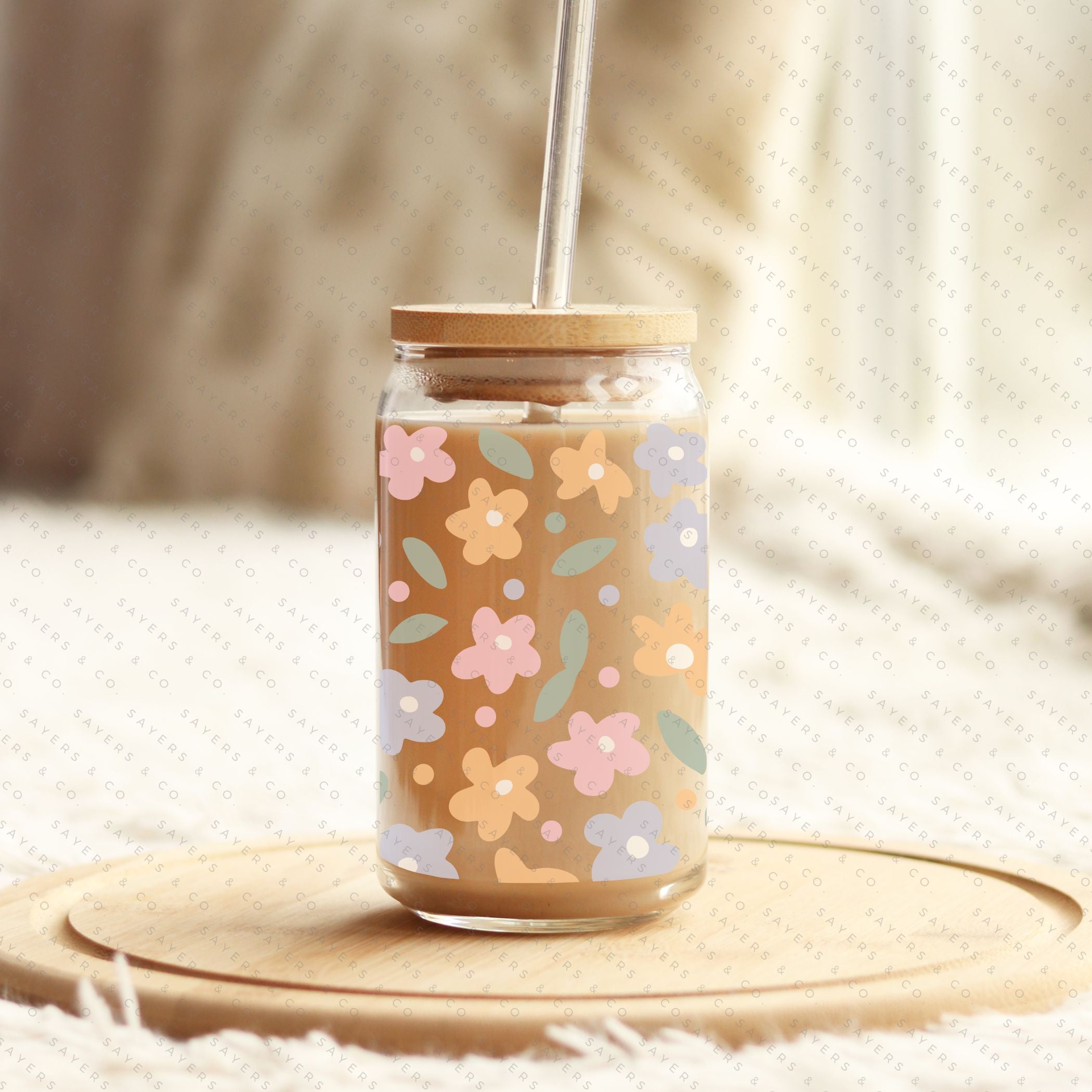 16oz Spring Pastel Petals Glass Cup featuring a bamboo lid and straw, adorned with colorful floral designs, perfect for beverages.